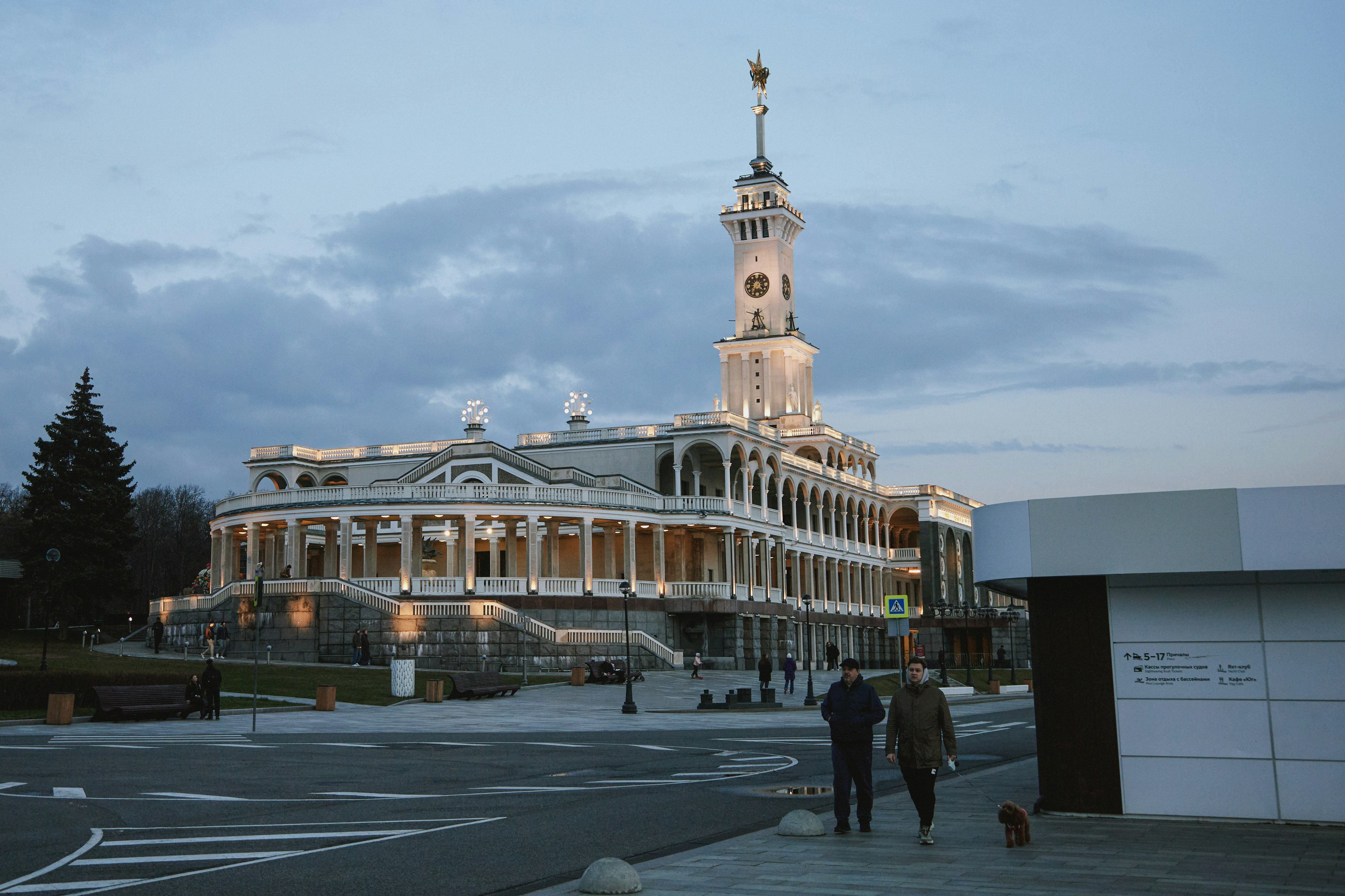 Grand building with a tall clock tower at dusk