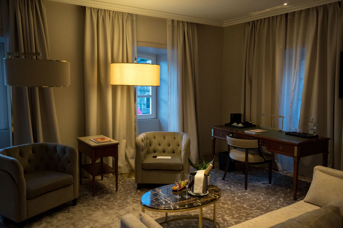 A hotel room with seating and a desk