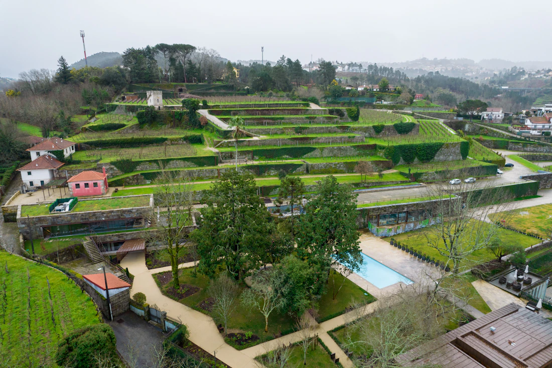 Terraced gardens with a pool and houses