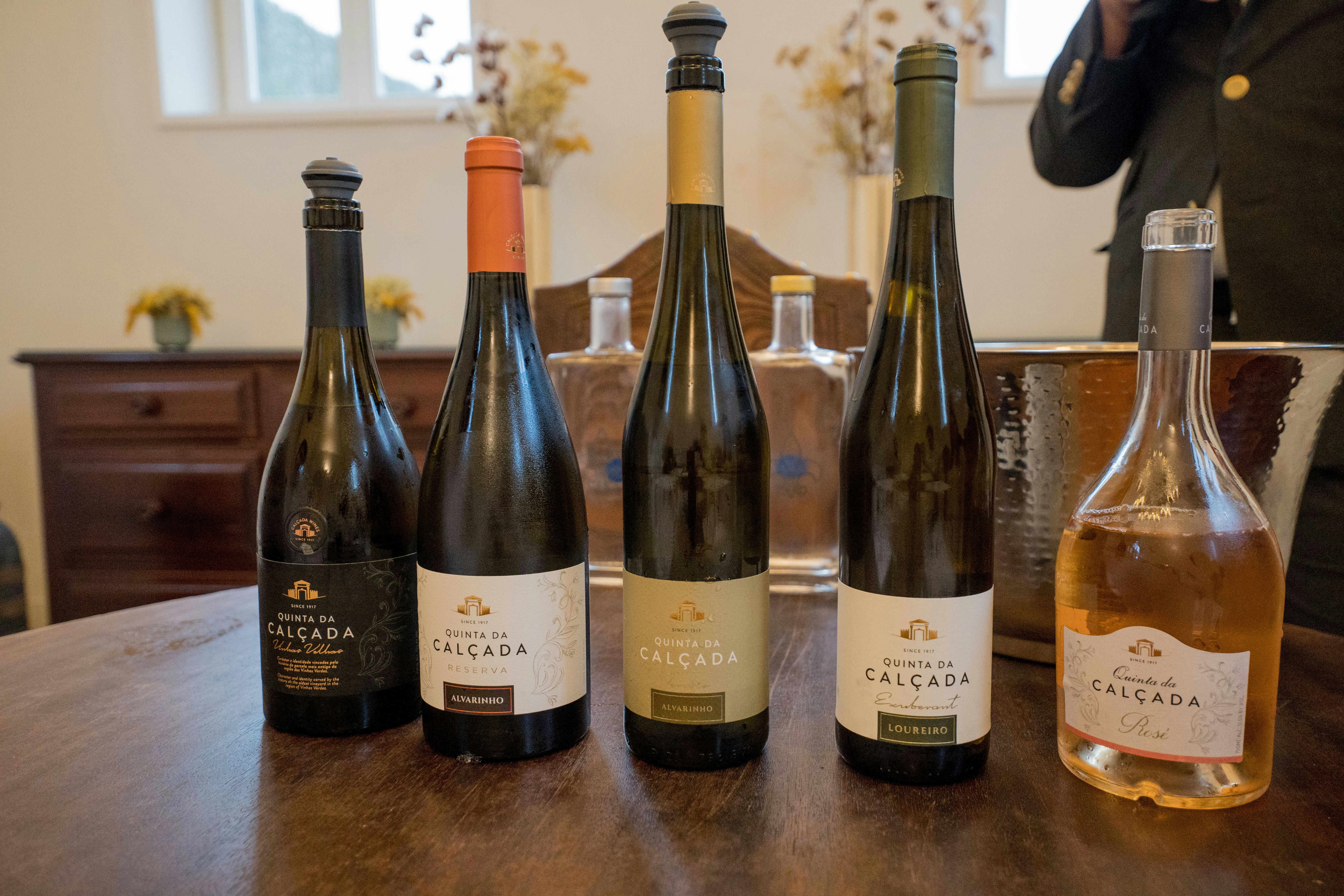 Five bottles of wine arranged on a table