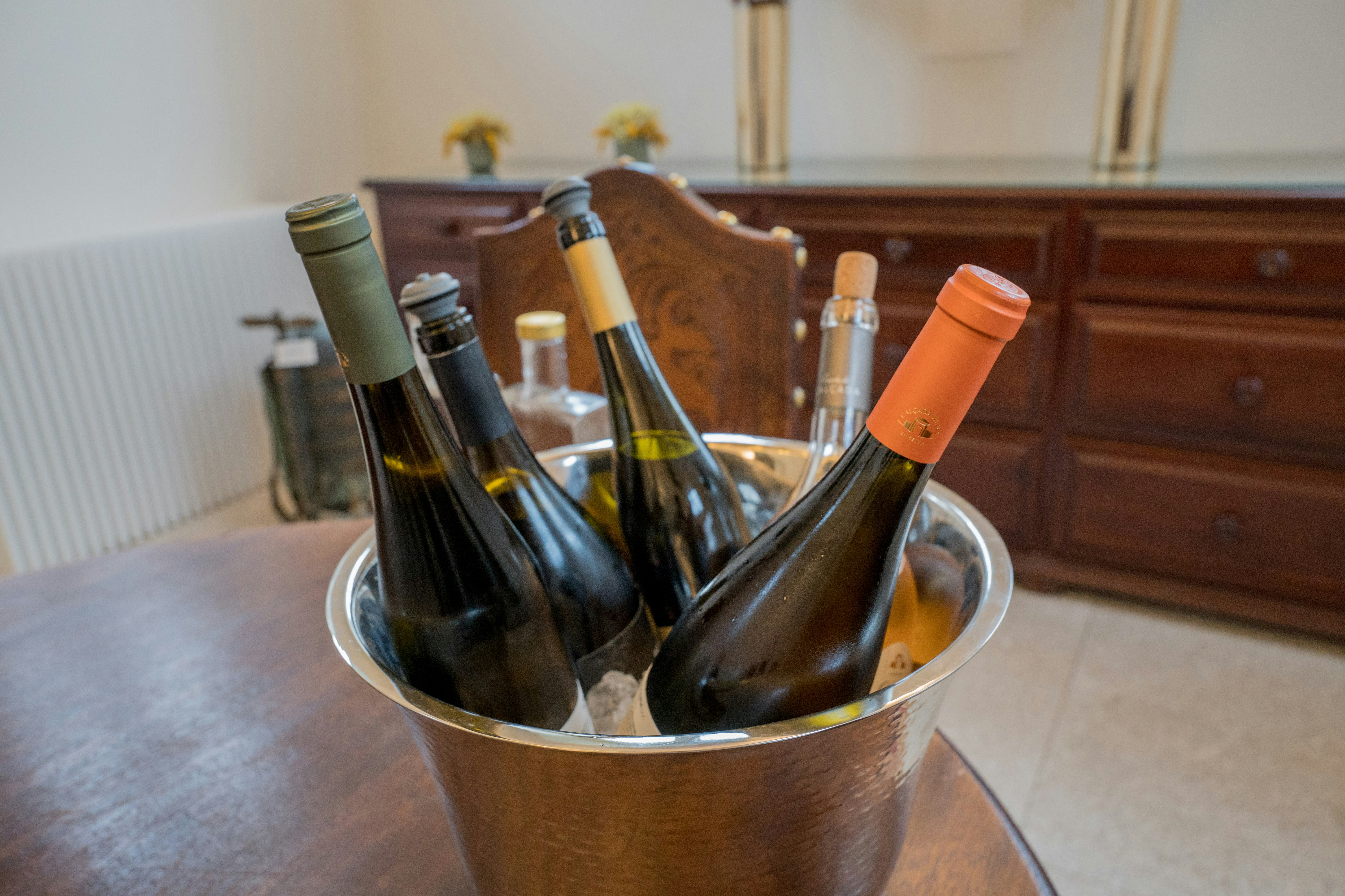 Four wine bottles chilling in an ice bucket