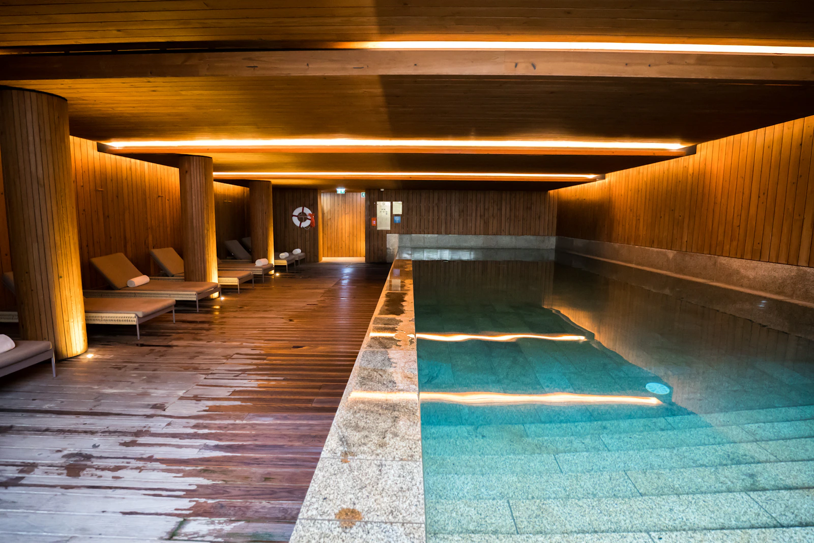 Illustrative luxury indoor spa pool and relaxation loungers