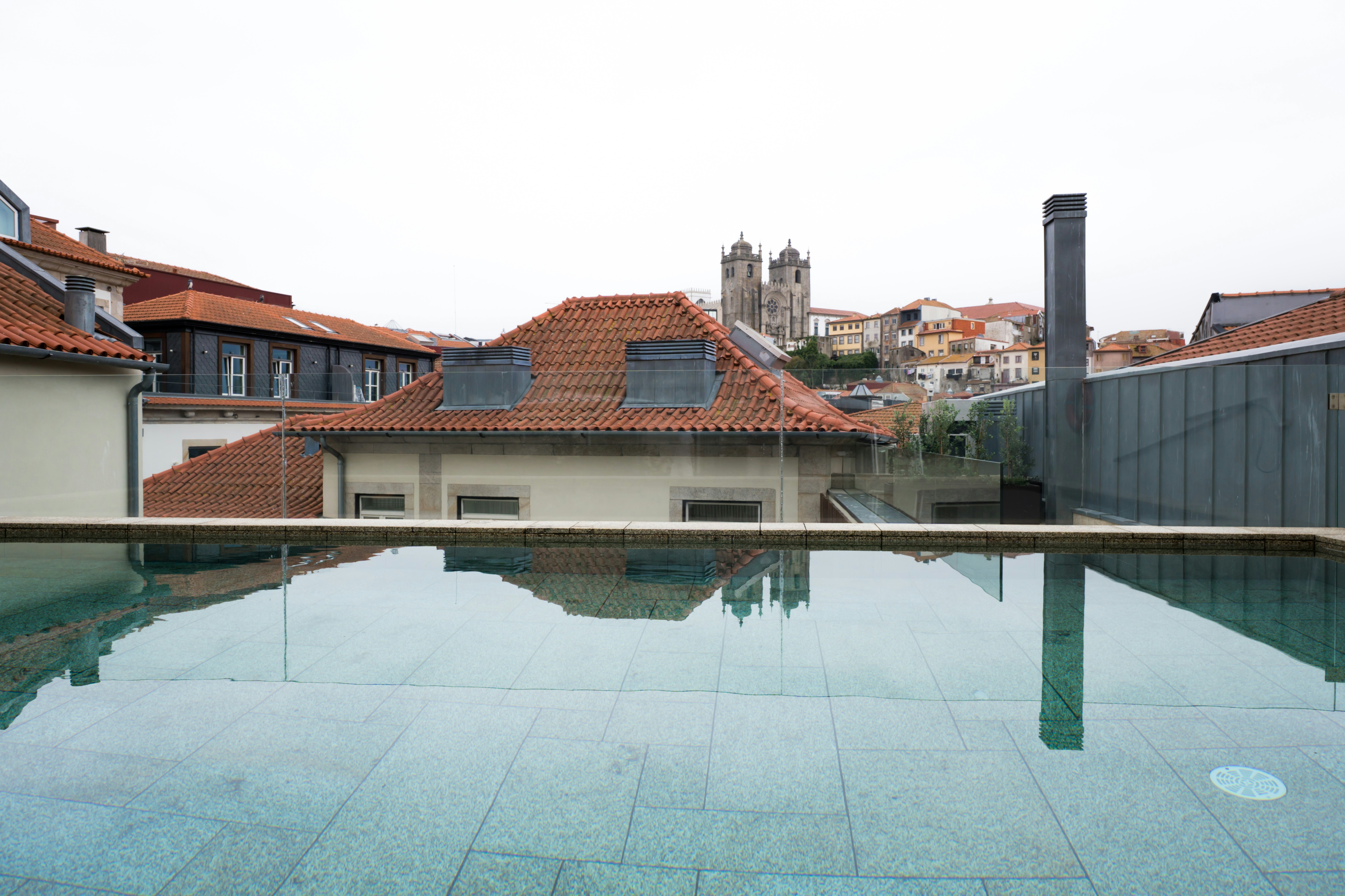 Infinity pool overlooking historic european city rooftops