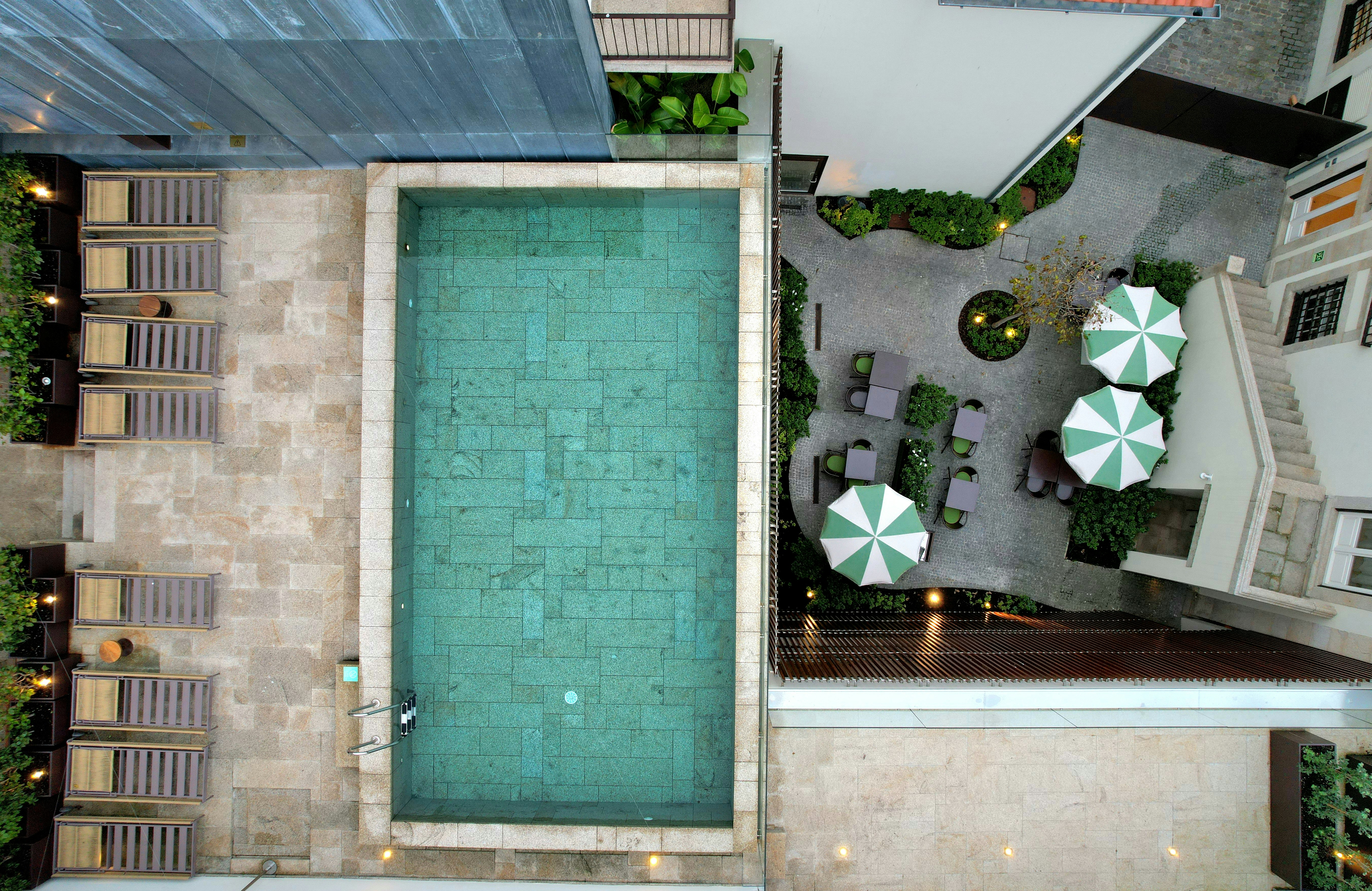 Aerial view of a resort swimming pool and lounge chairs.