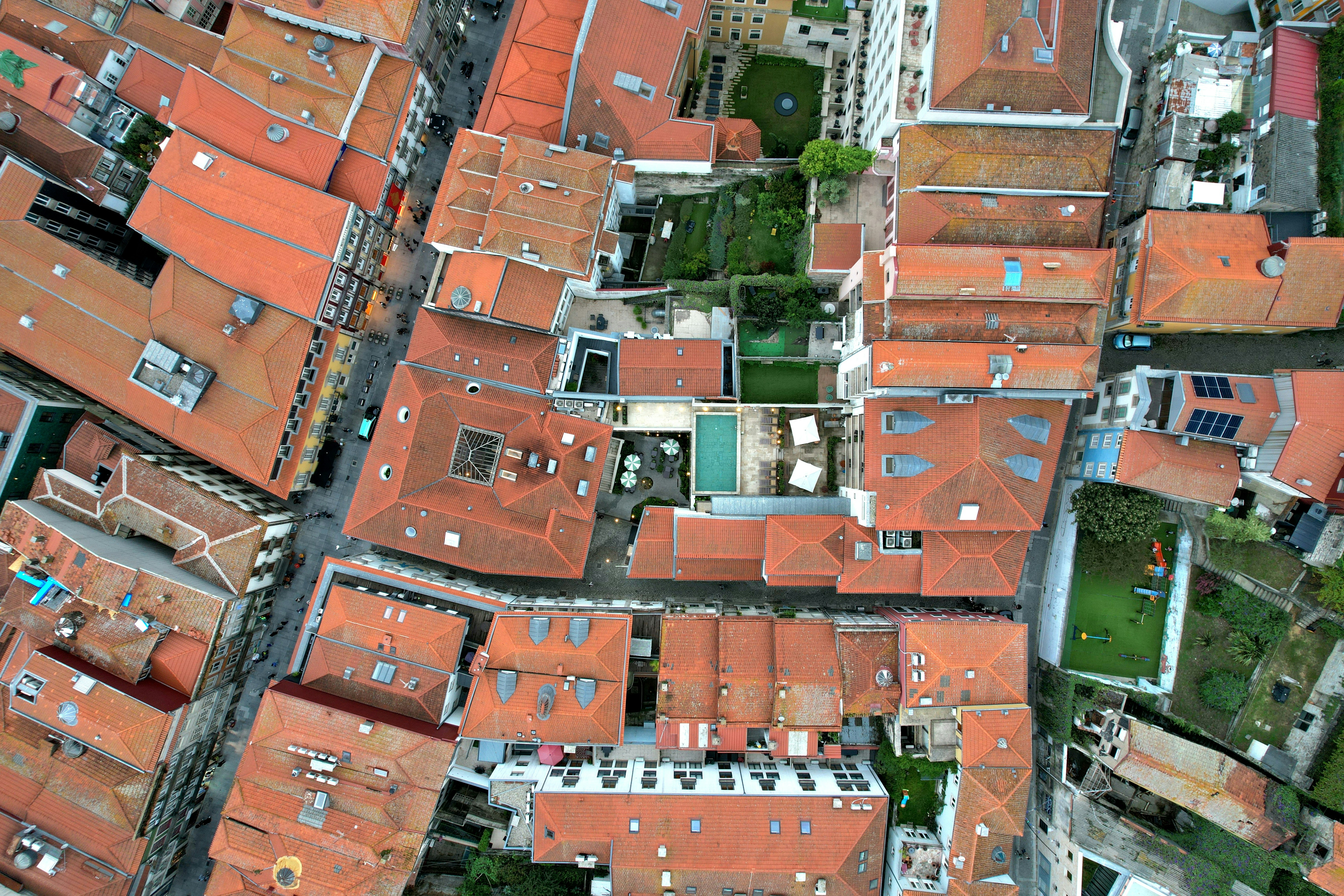 Aerial view of red tiled rooftops and courtyards.