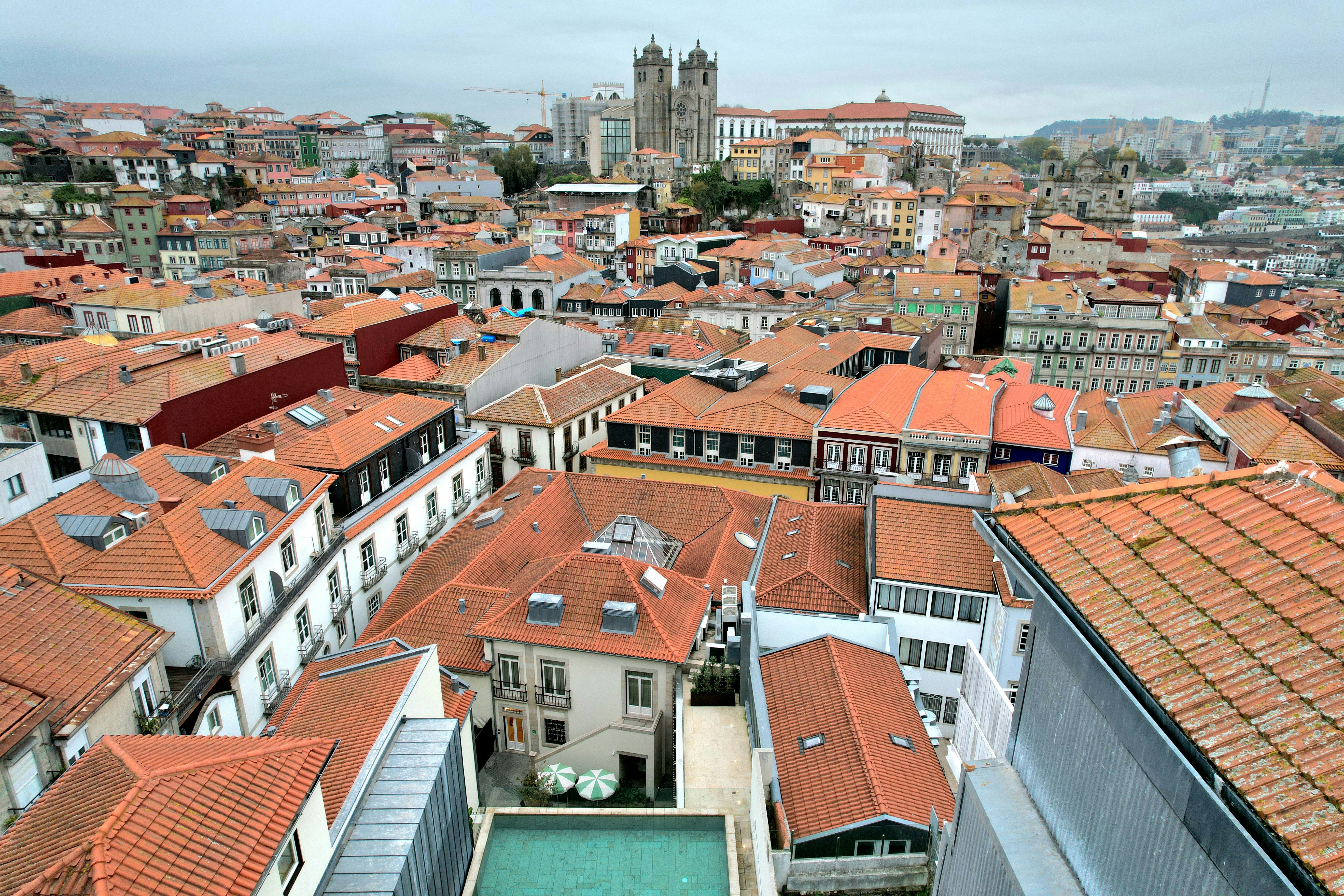 Rooftops of a european city with distant towers.