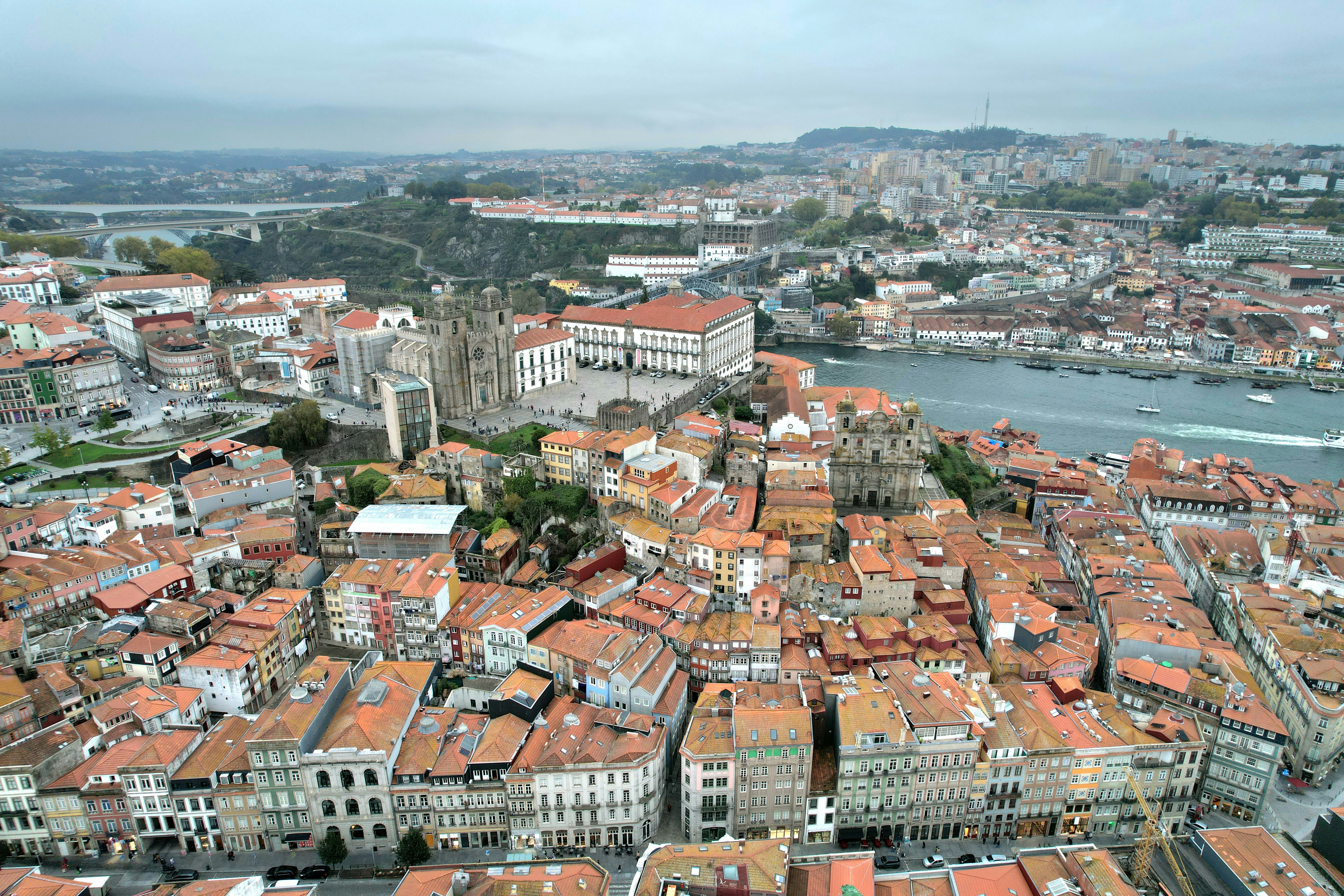 Aerial view of a dense european city with terracotta roofs.