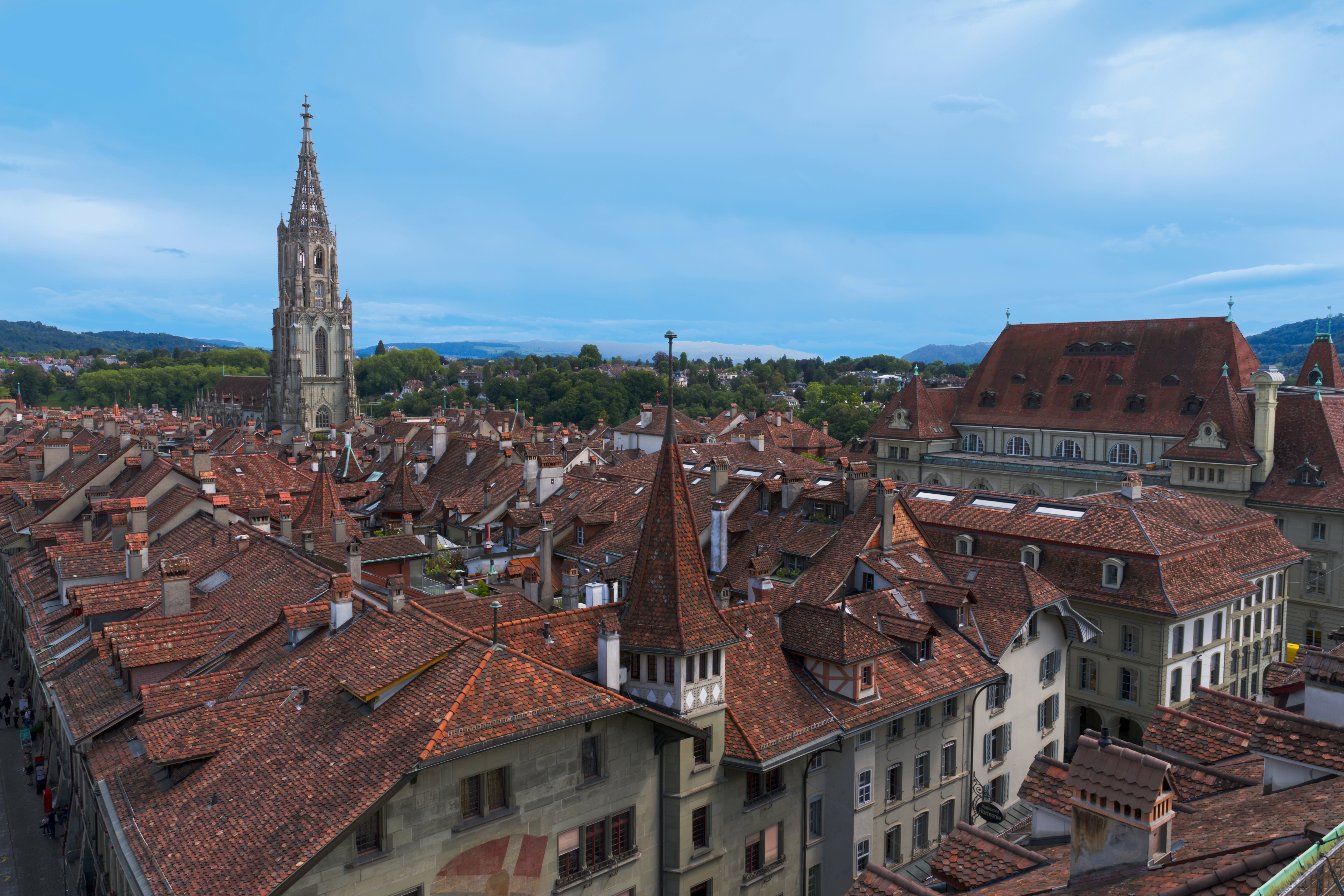 Rooftops and a tall church spire in bern, switzerland.