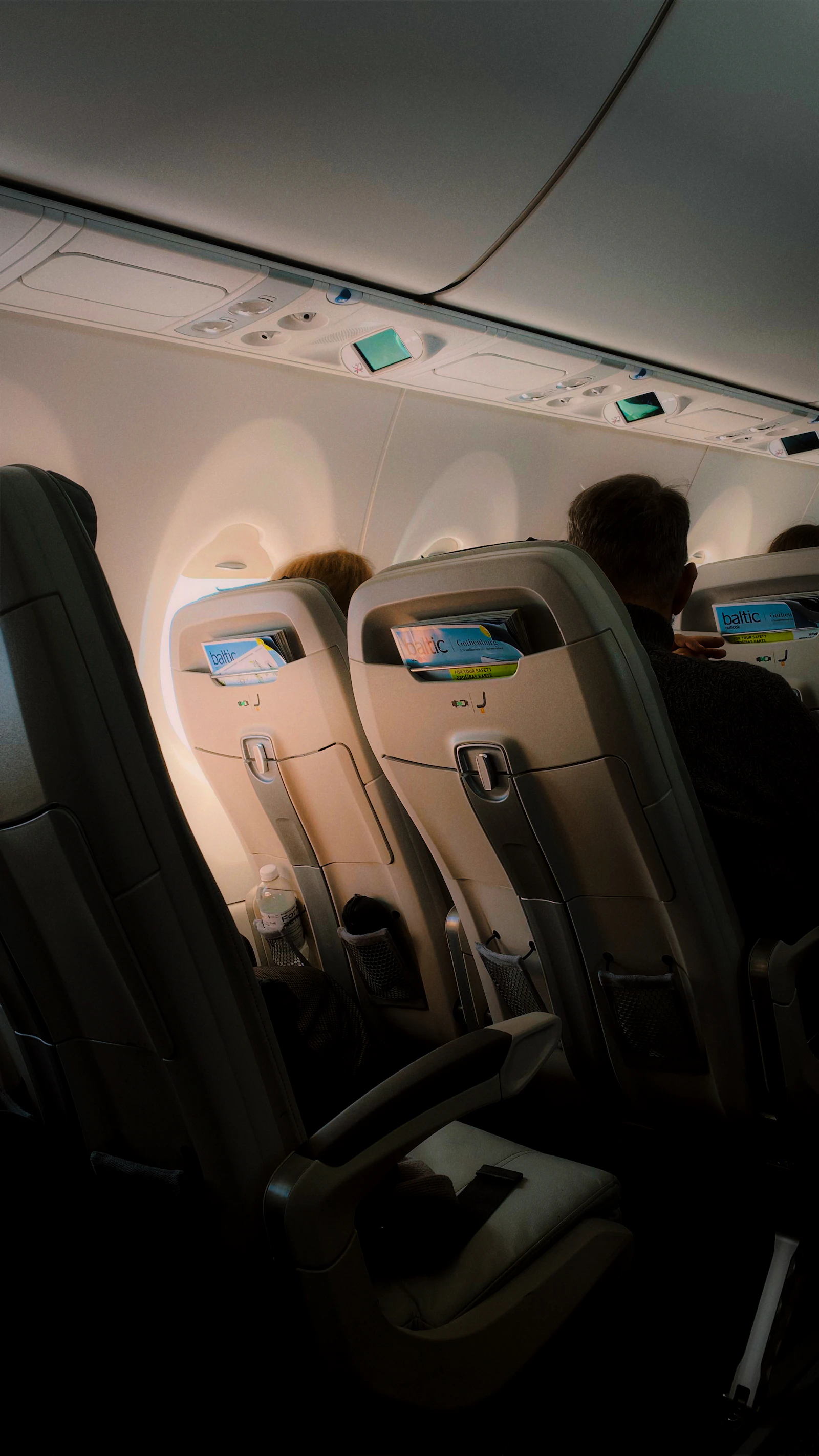Passengers seated in an airplane cabin during a flight