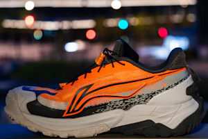 Orange and white athletic running shoe