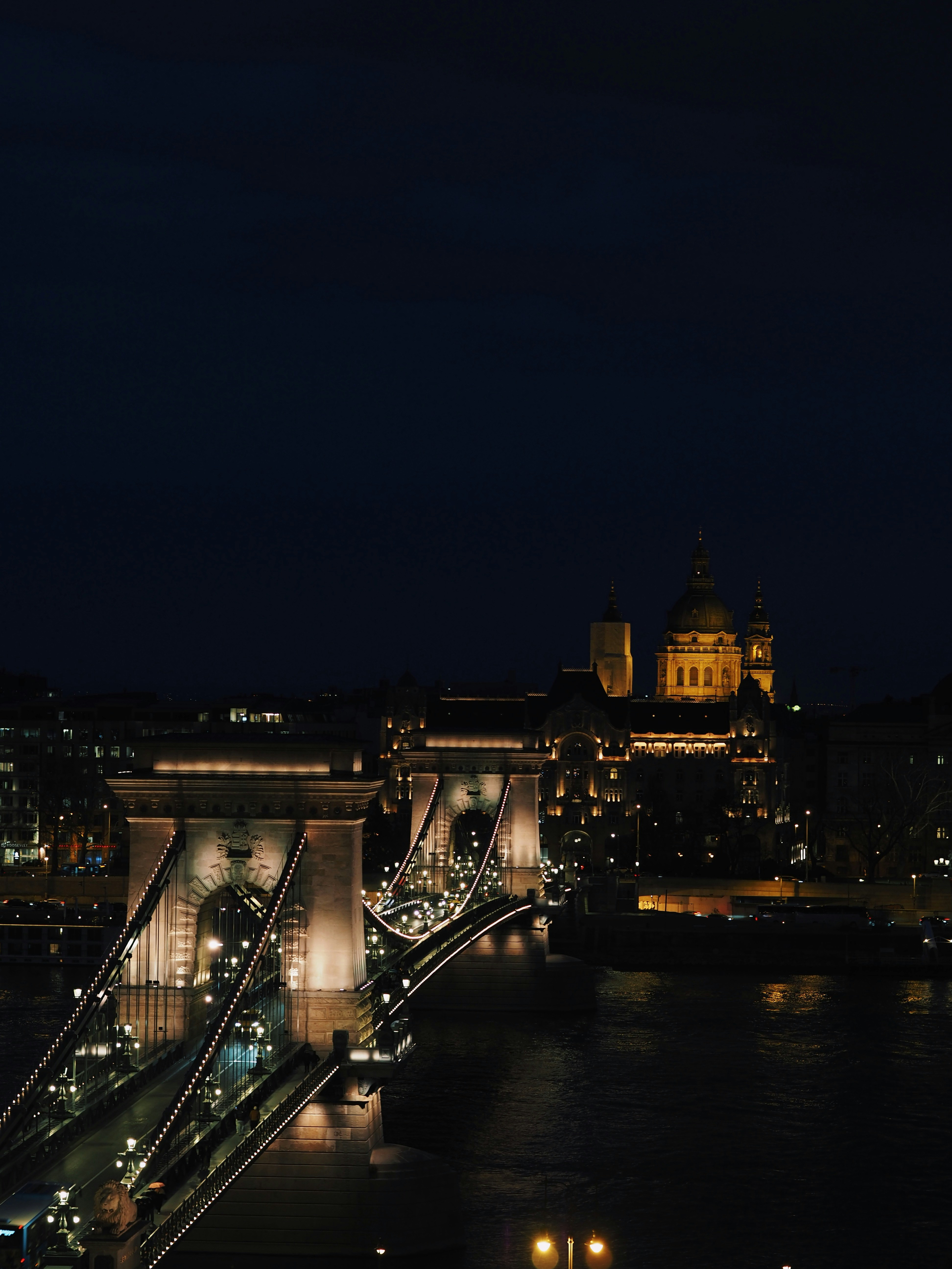 Illuminated bridge and buildings at night
