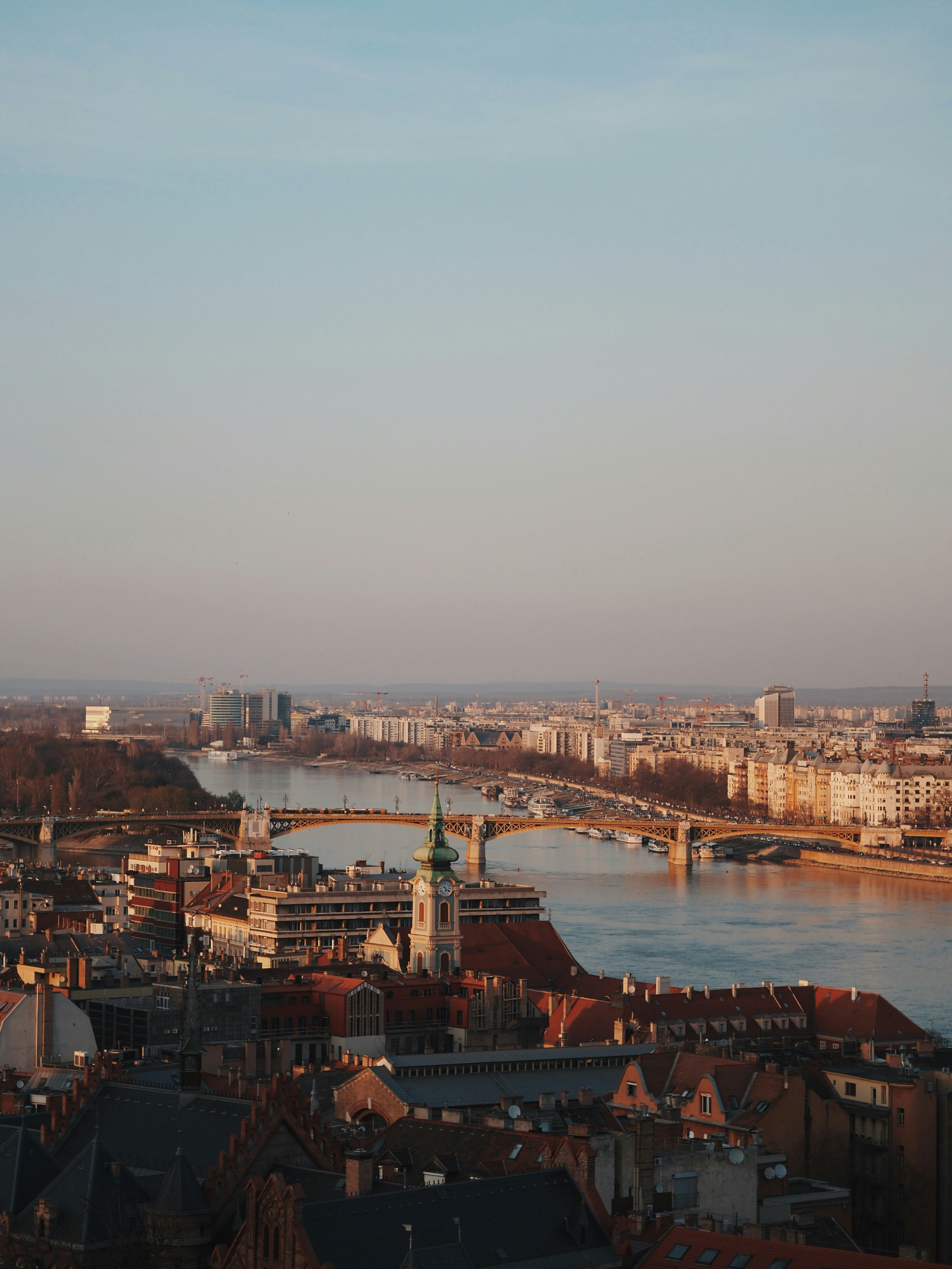 Cityscape with river and bridge at sunset