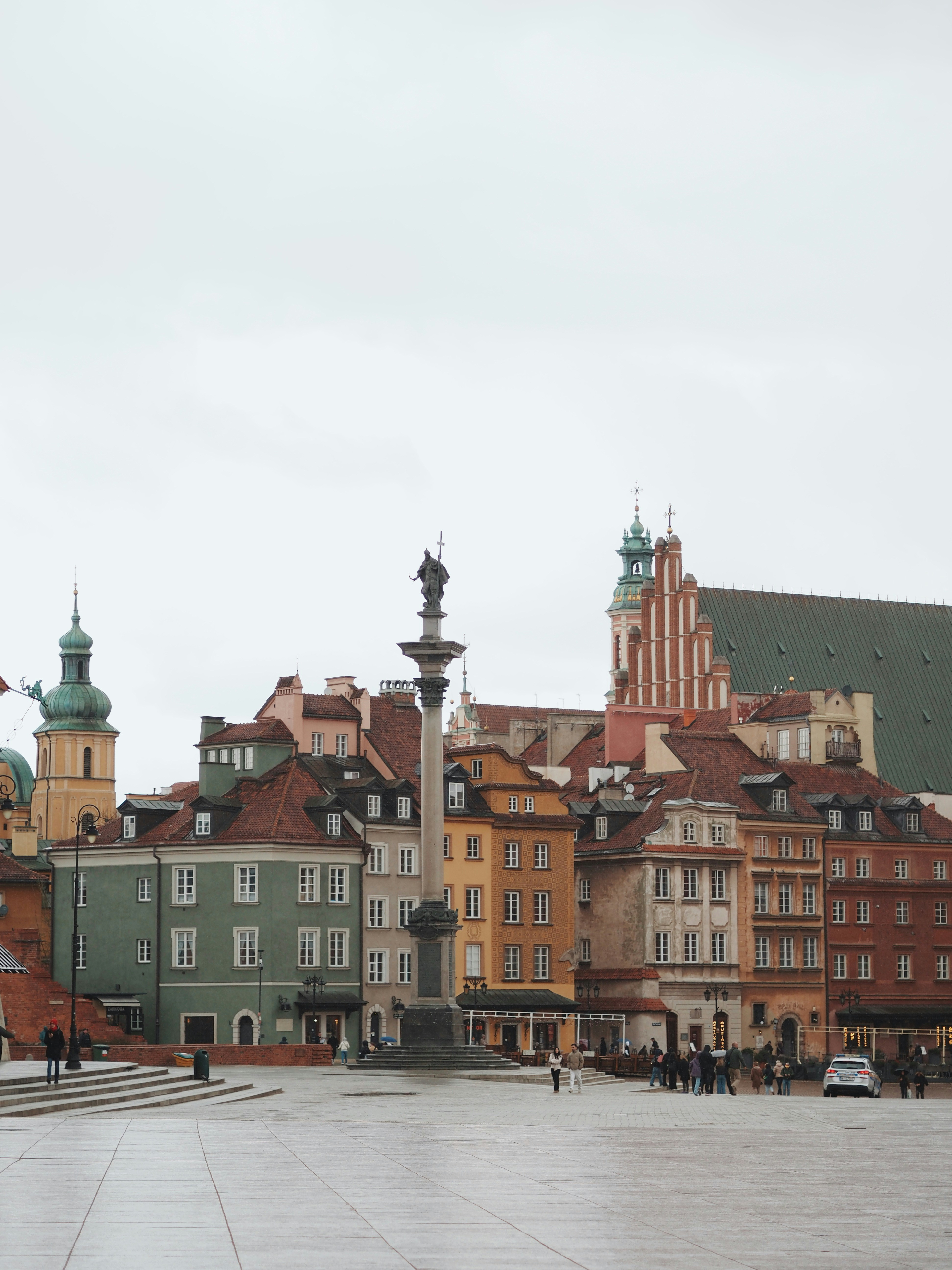 Colorful historic buildings surrounding a central monument.