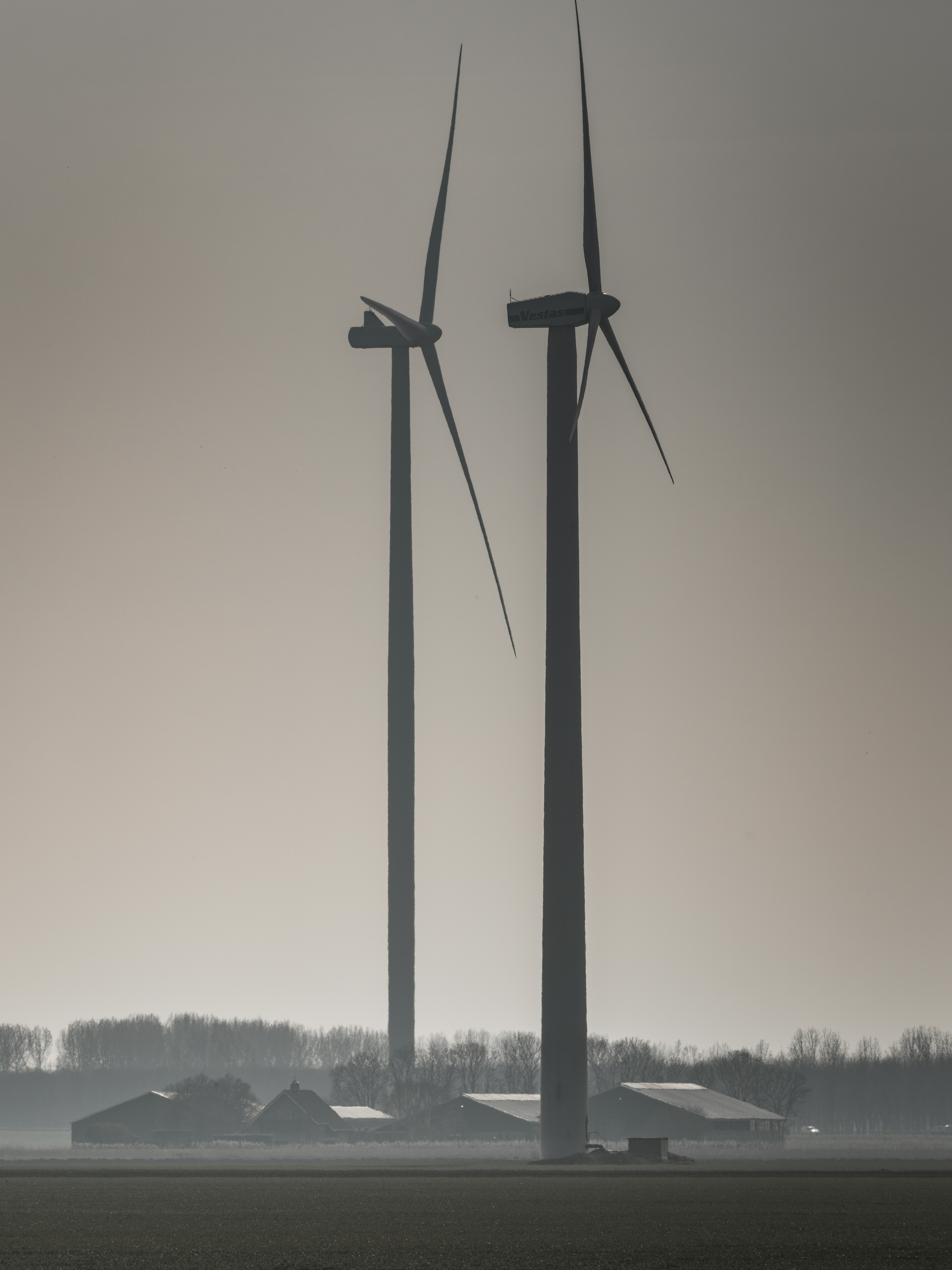 two wind turbines in an open field