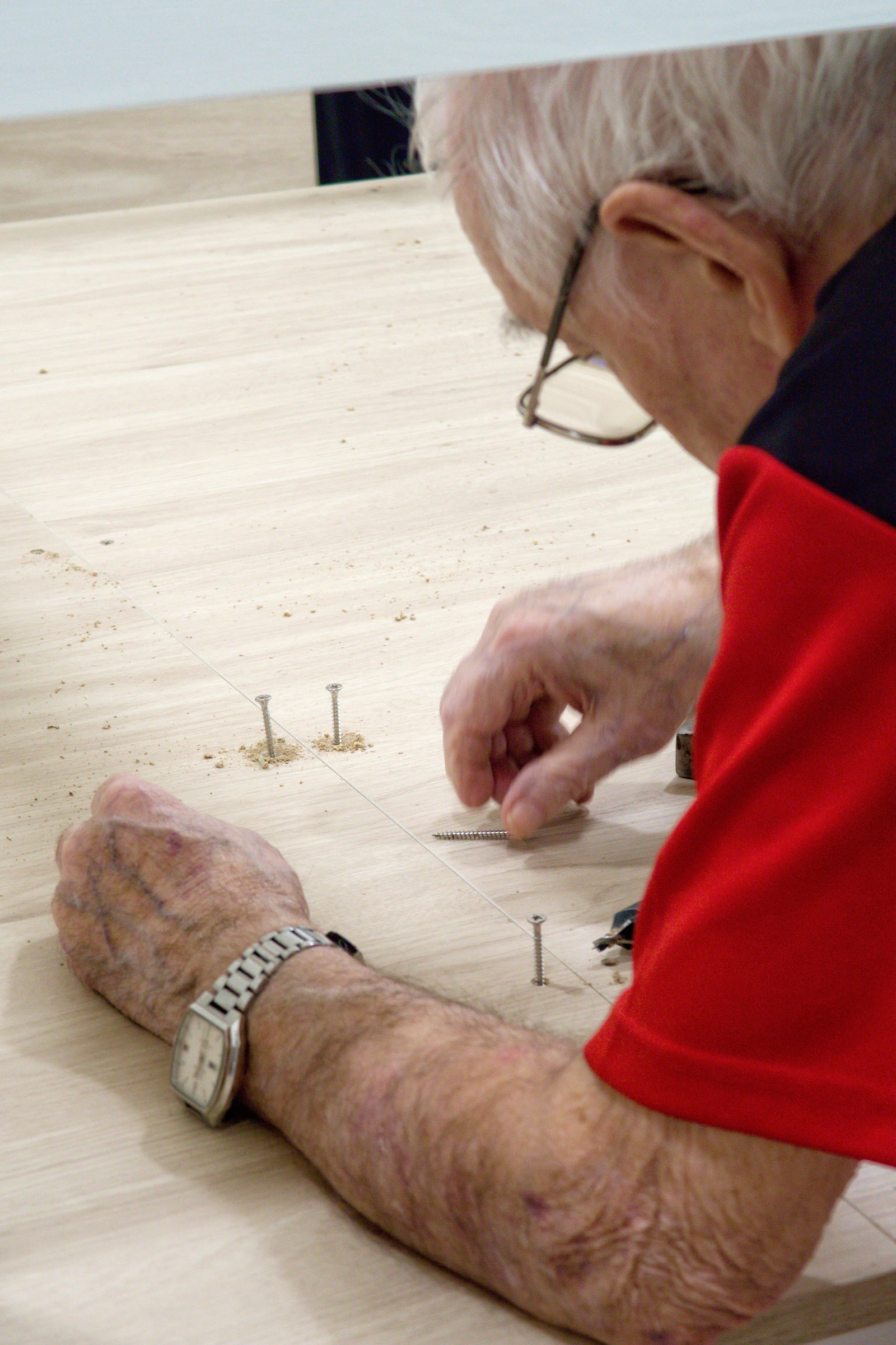 Craftsman hands working in a wood and leather workshop