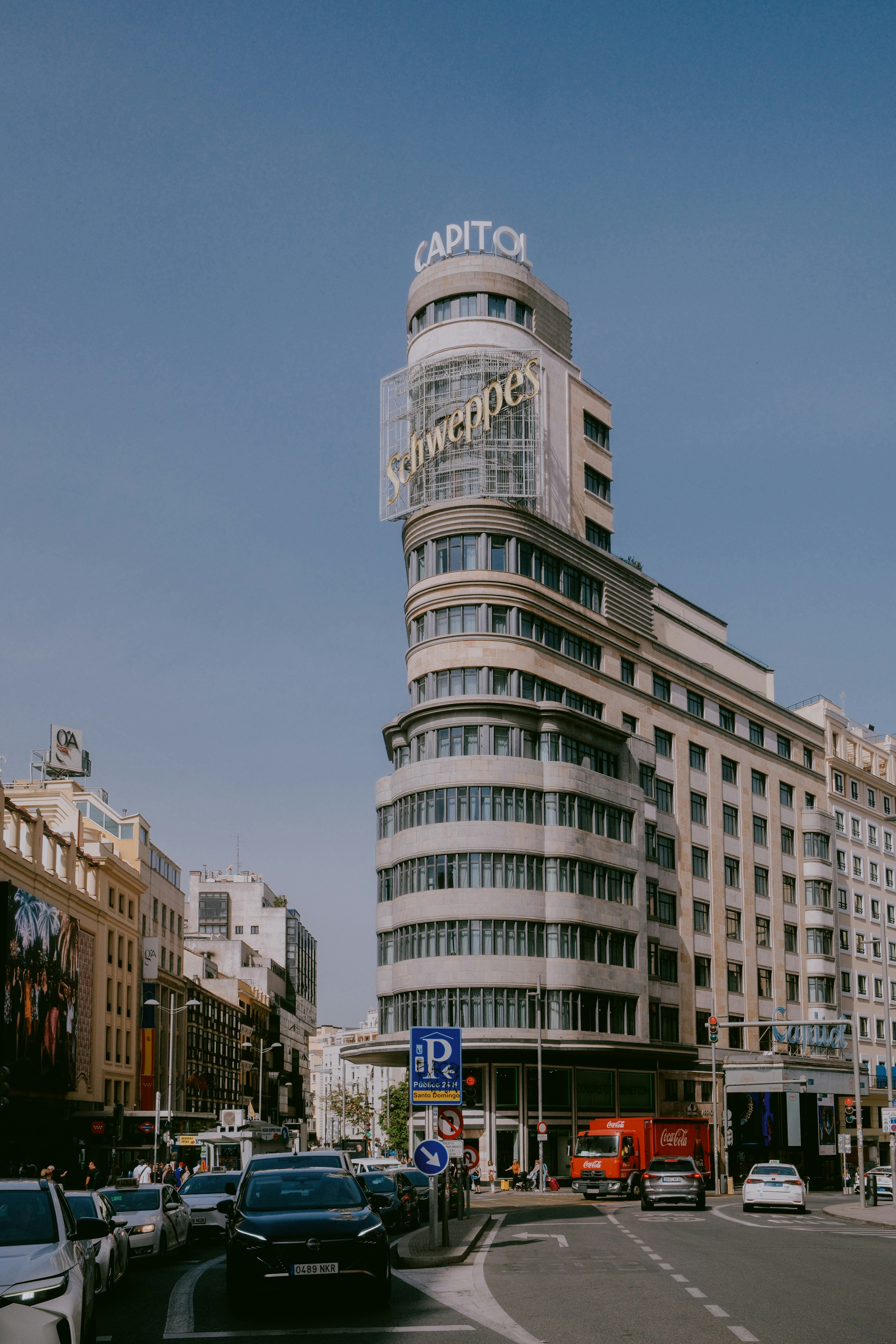Art deco building with schweppes sign in city