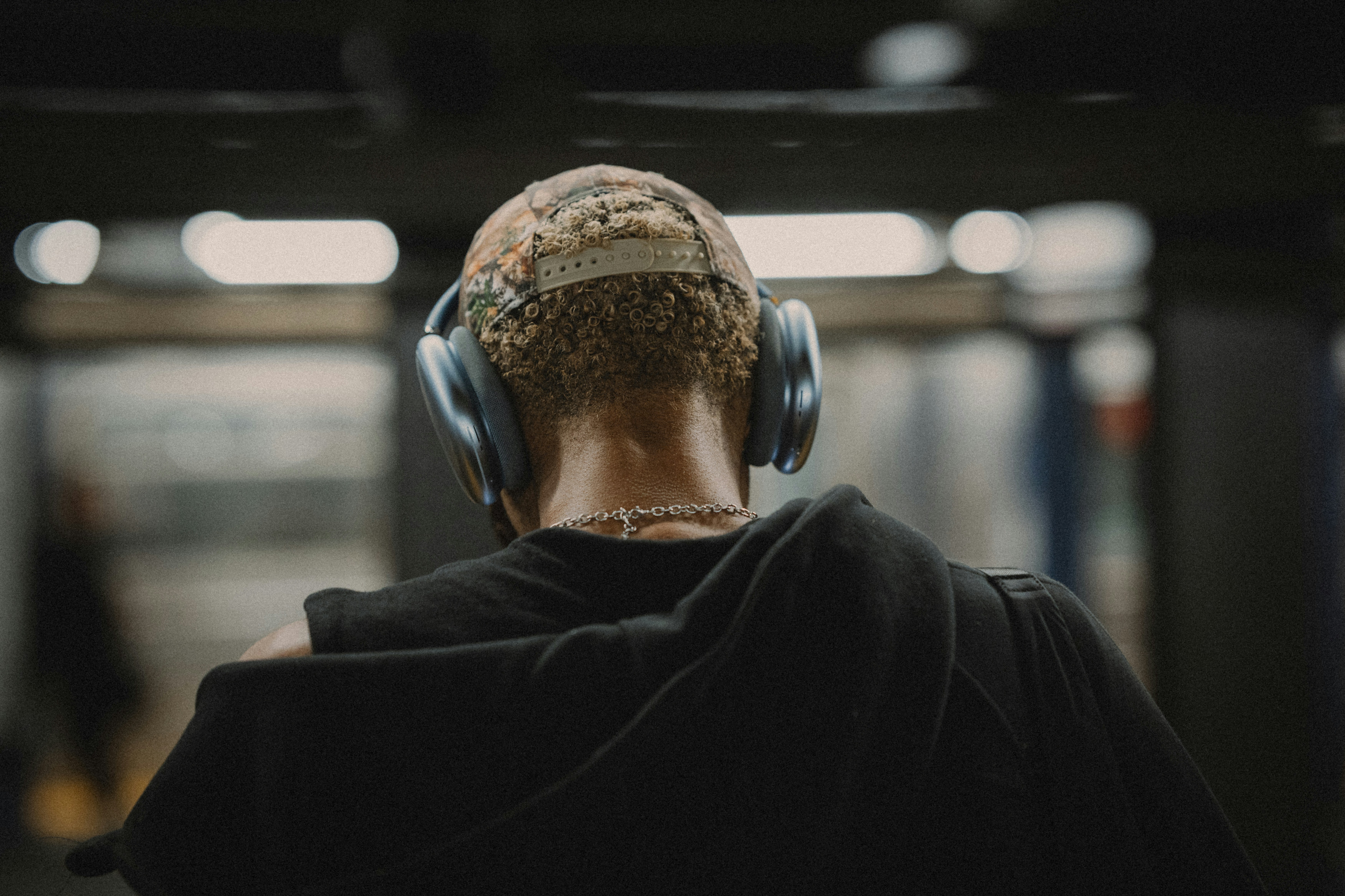 Person wearing headphones from behind