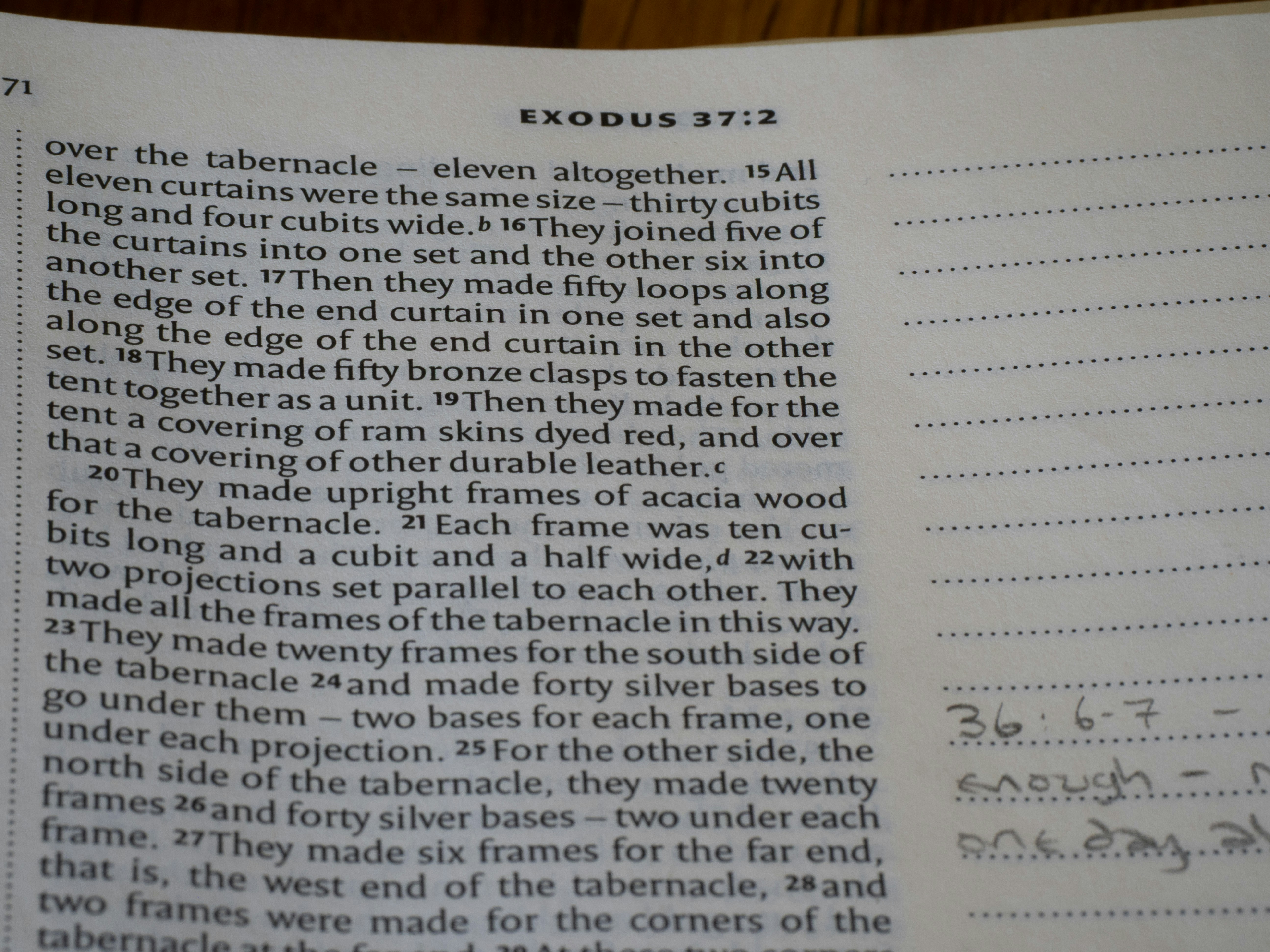 Close-up of an open bible page with text.