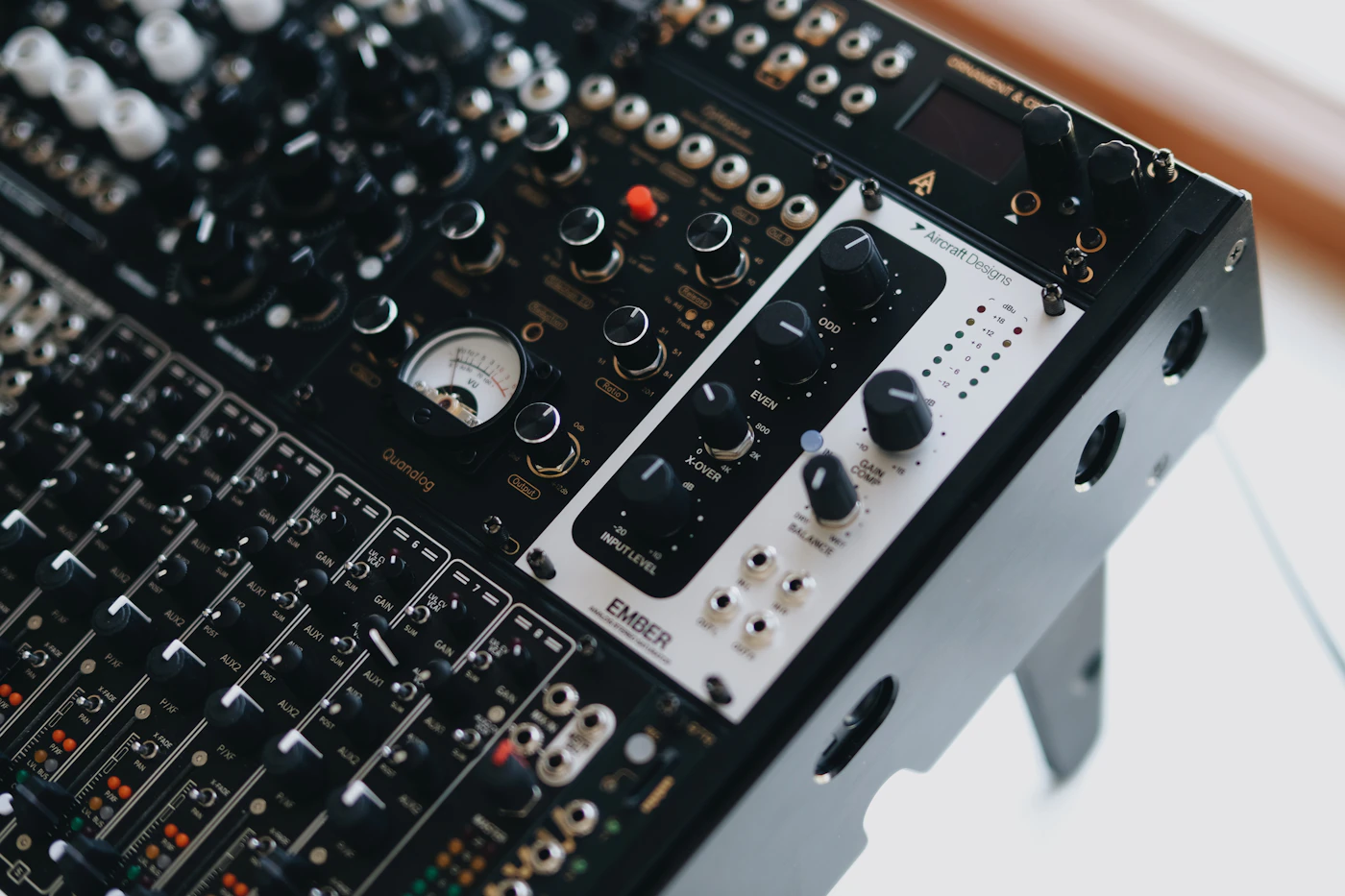 Close-up of a professional music production mixing console