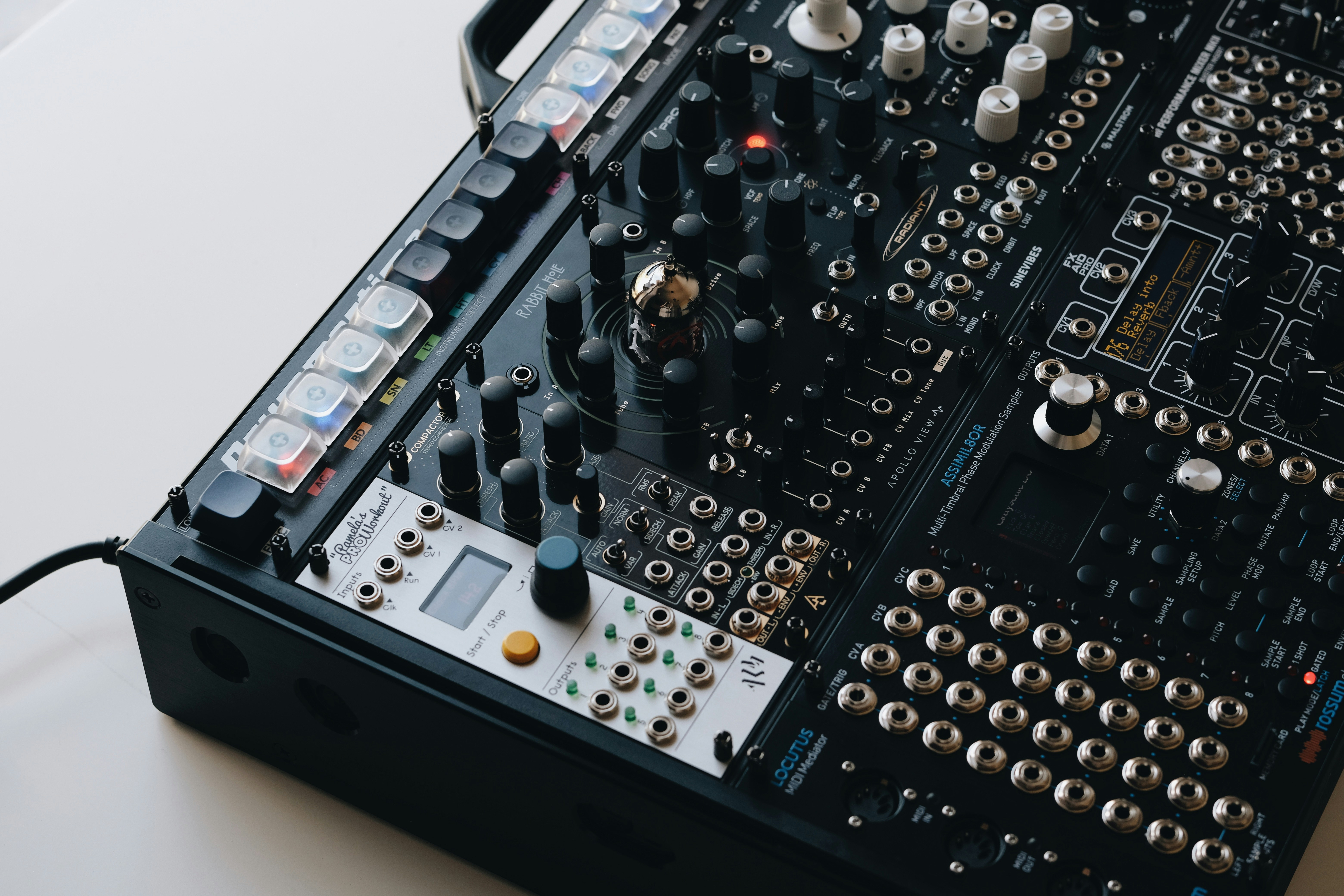 Close-up of a complex modular synthesizer with many knobs.