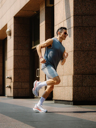 Man running on sidewalk in front of building