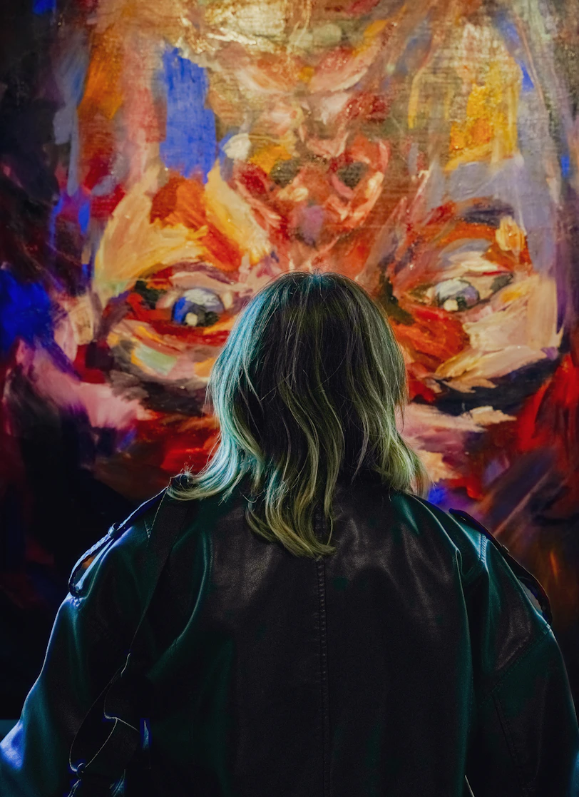 Person looking at a vibrant abstract painting