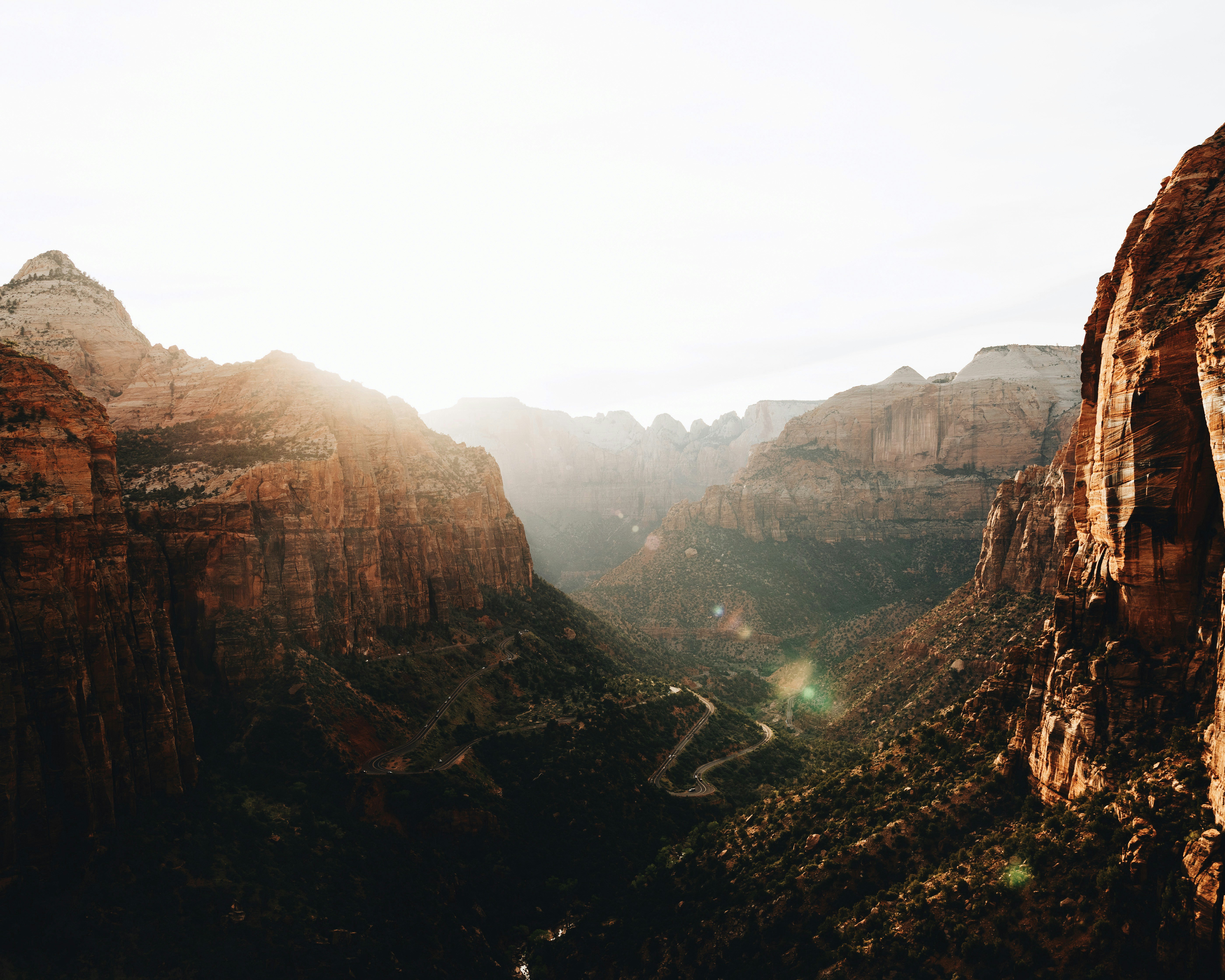Sunlight streams through a canyon landscape