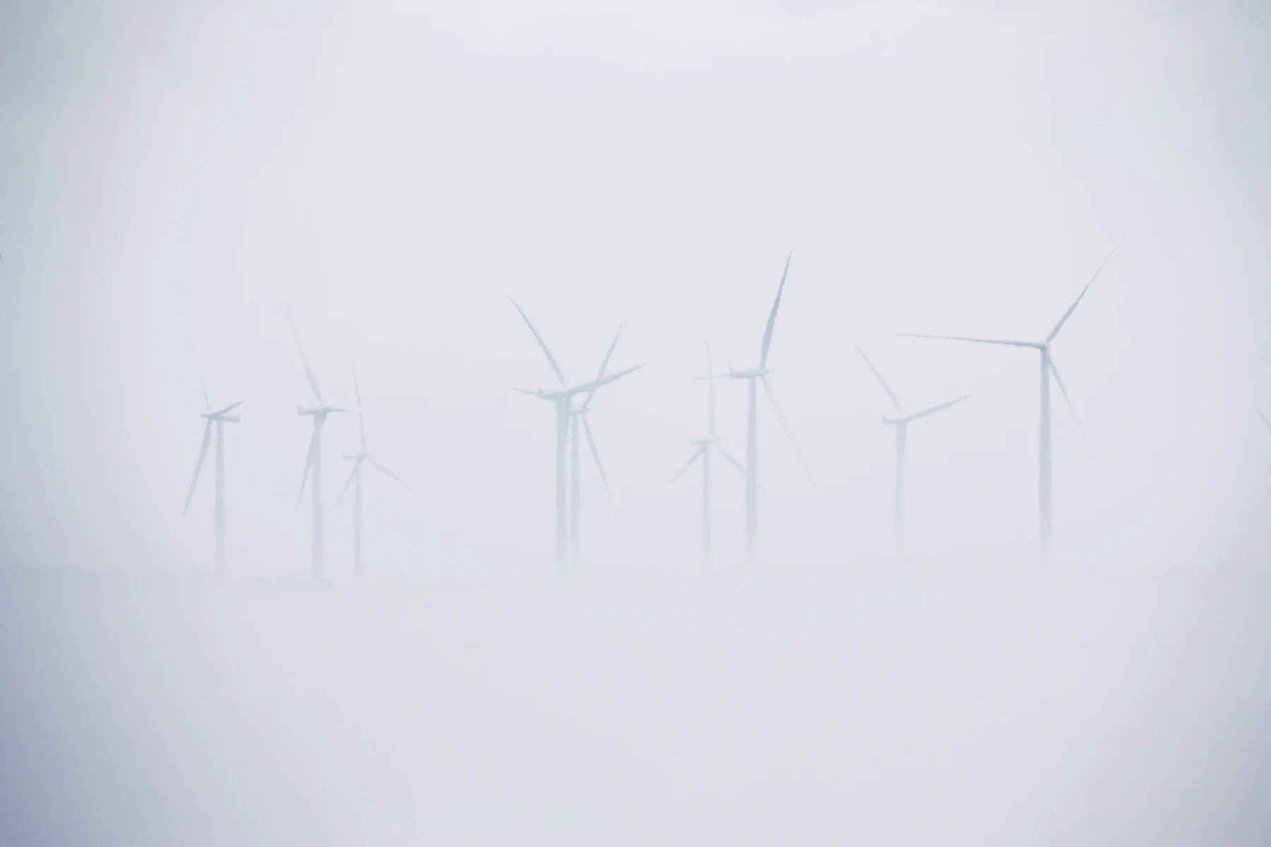 Wind turbines in a misty landscape