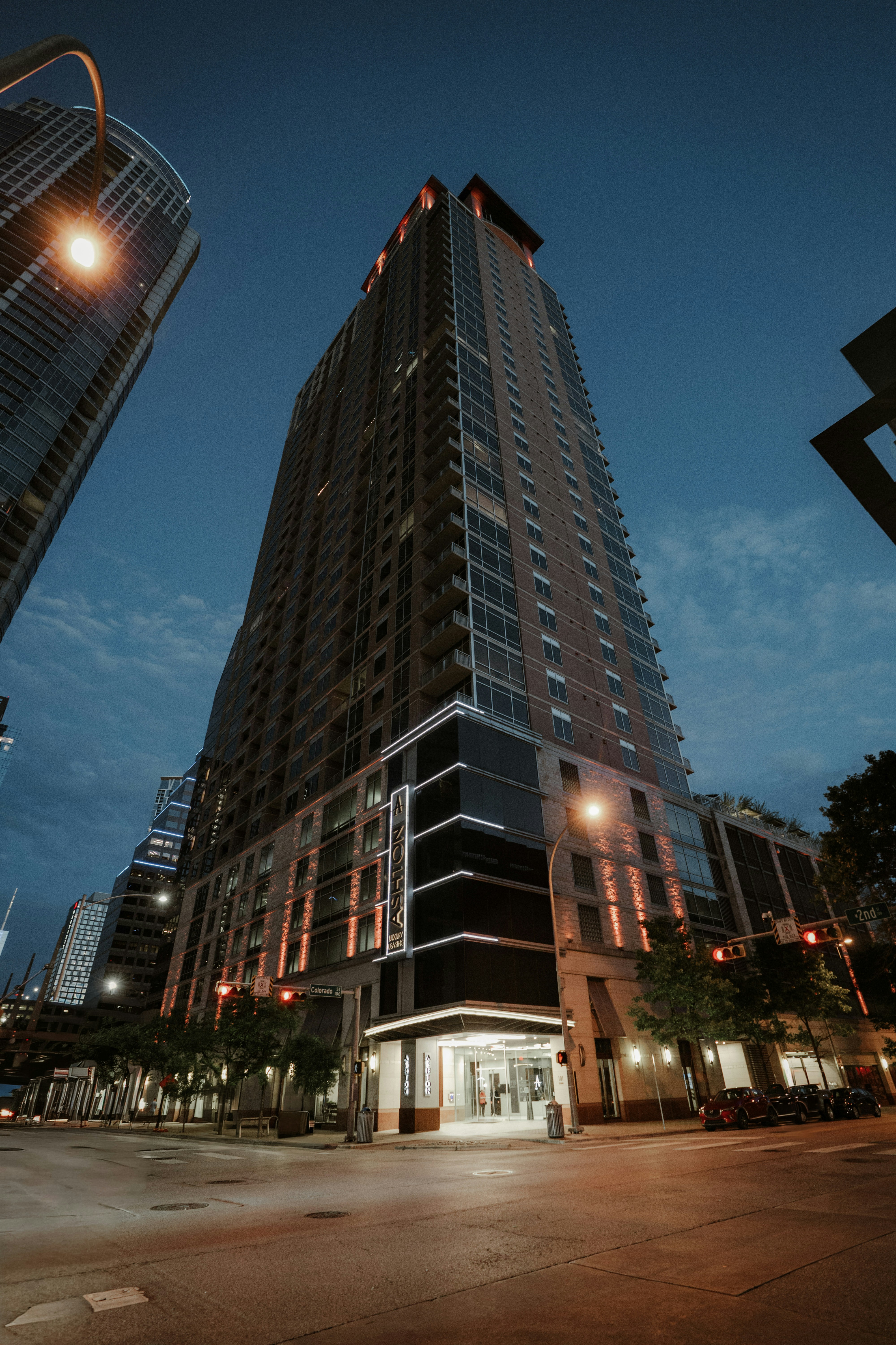 Tall modern skyscraper illuminated at dusk