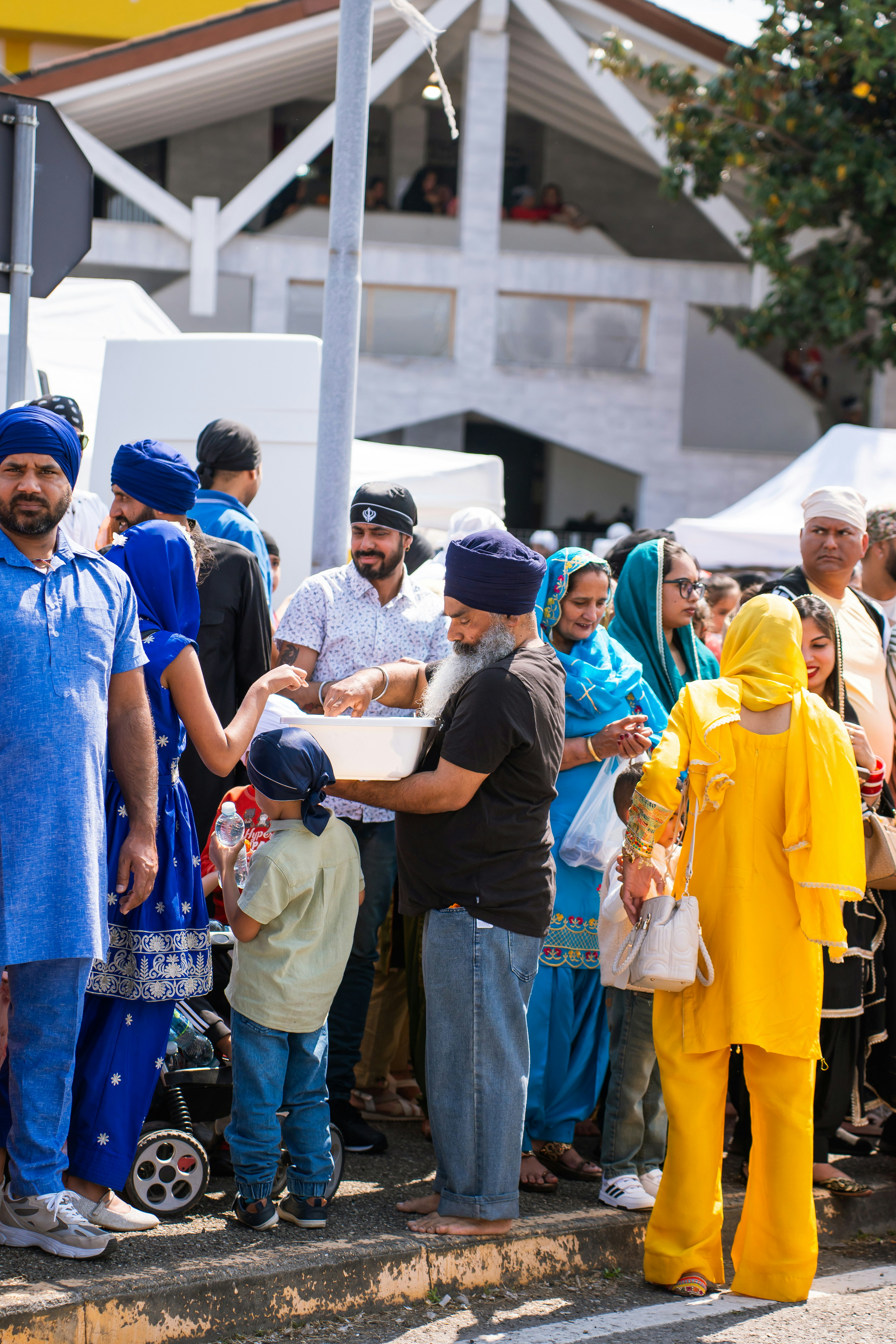 People in traditional clothing gathered outdoors.