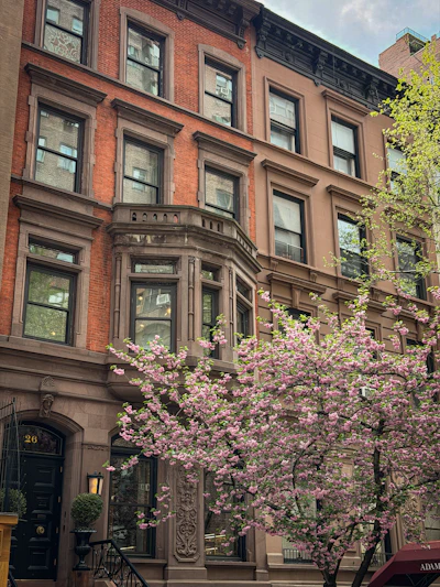 Brownstone townhouse frontage of The Marrowbone House in spring — photo by Nataliia Kvitovska on Unsplash
