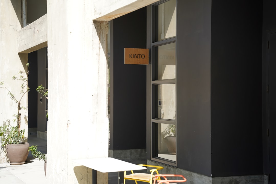 Modern building entrance with a small table and chairs.
