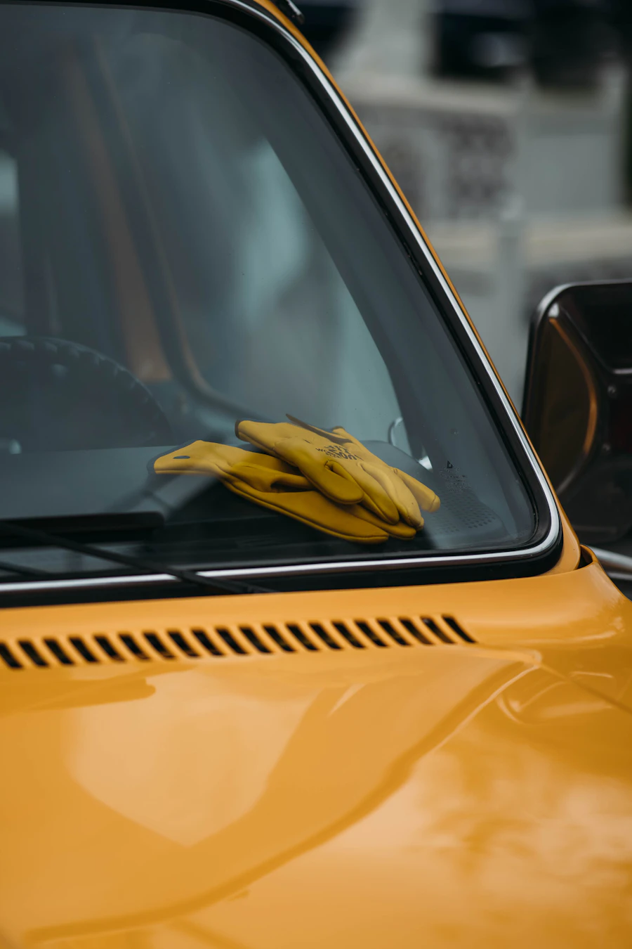 Yellow work gloves resting on a truck dashboard — your dispatch software runs while you work