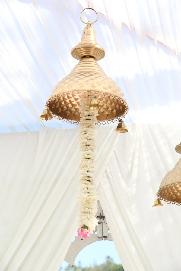 Ornate golden lantern decorated with a floral garland