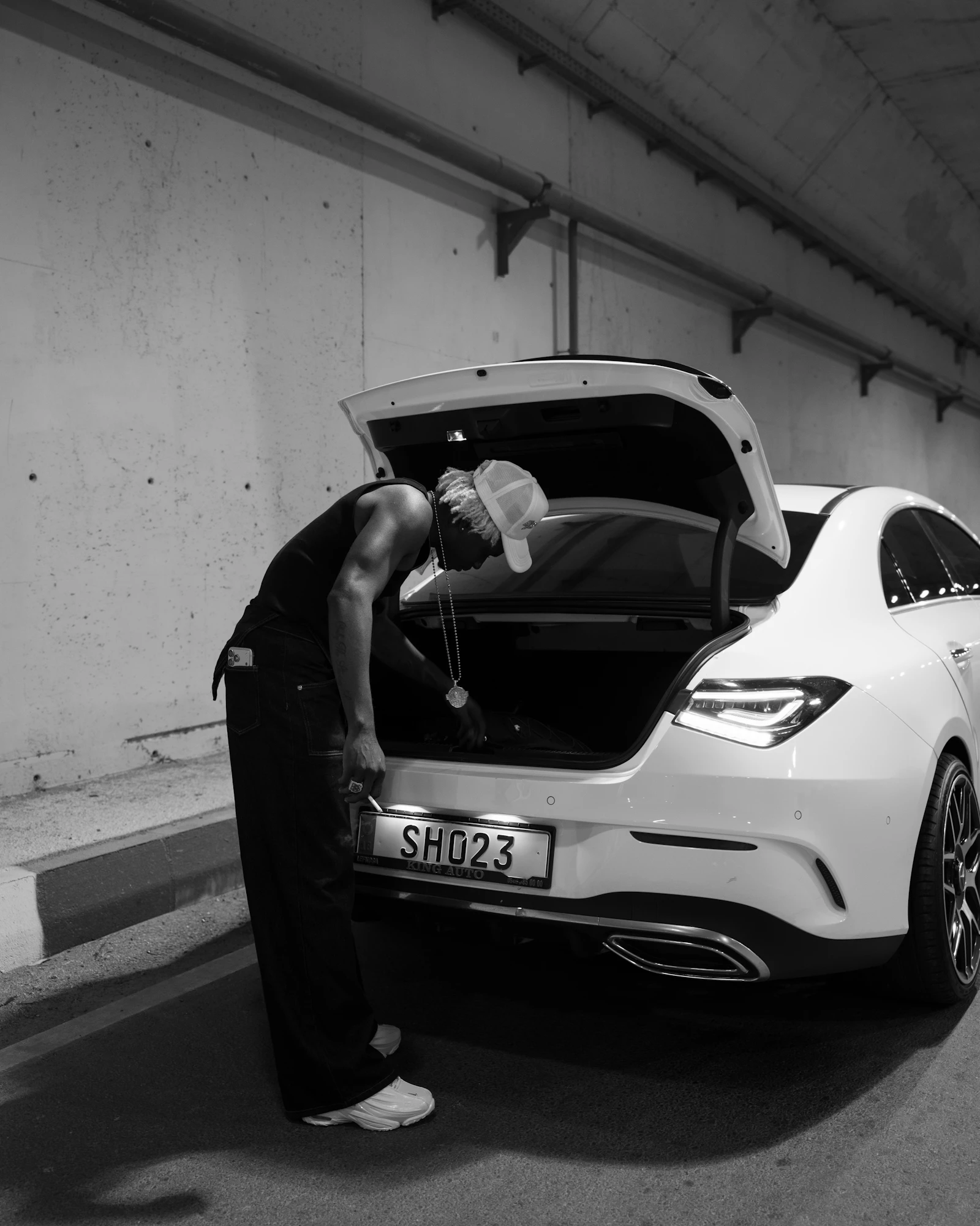 Person loading items into the trunk of a modern car