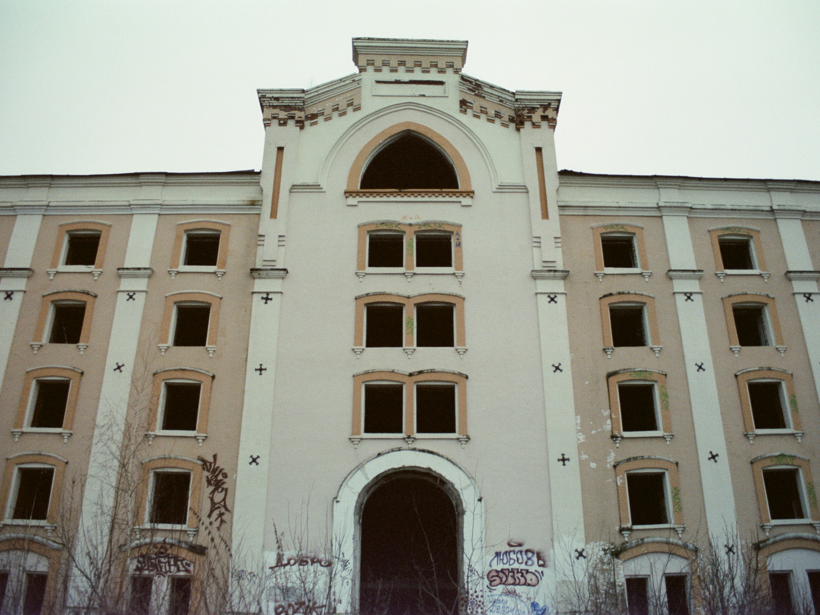 Abandoned building with boarded up windows and graffiti