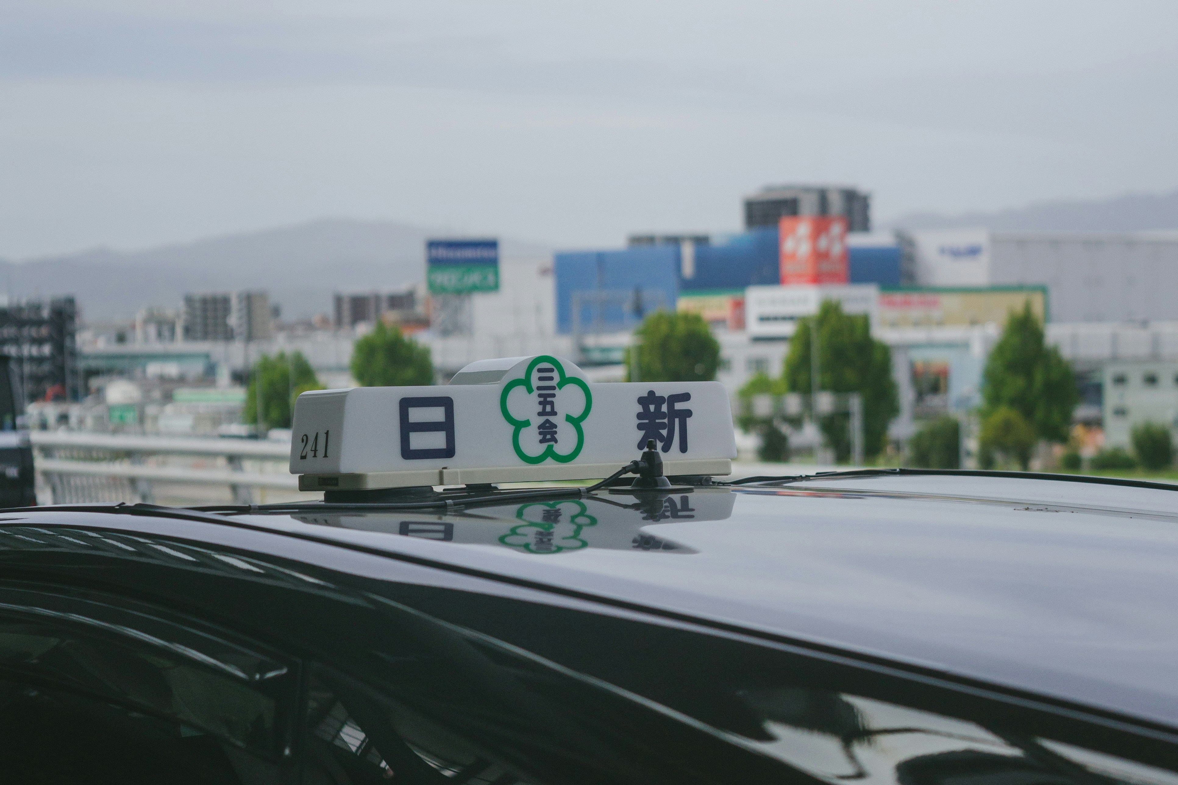 Taxi sign with japanese characters on a car roof