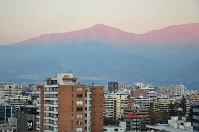 The Santiago skyline at dusk with the snow line of the Andes behind it