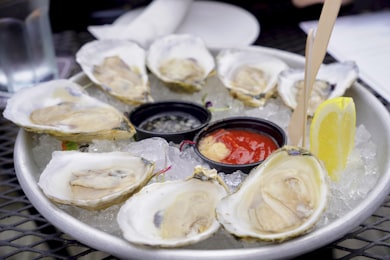 Plateau d'huîtres sur glace avec sauces et citron — grand service de brasserie