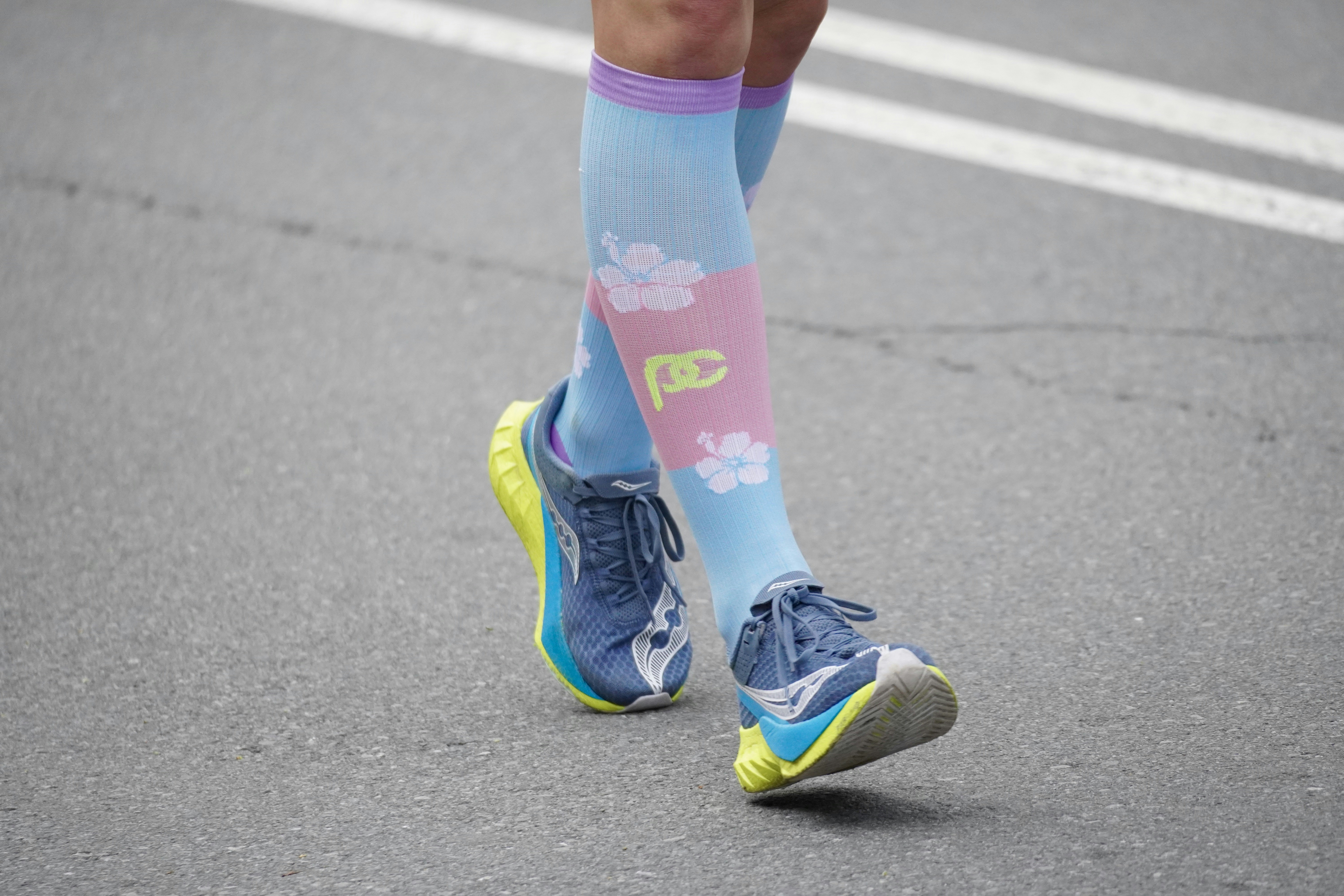 Runner's legs wearing colorful socks and athletic shoes.