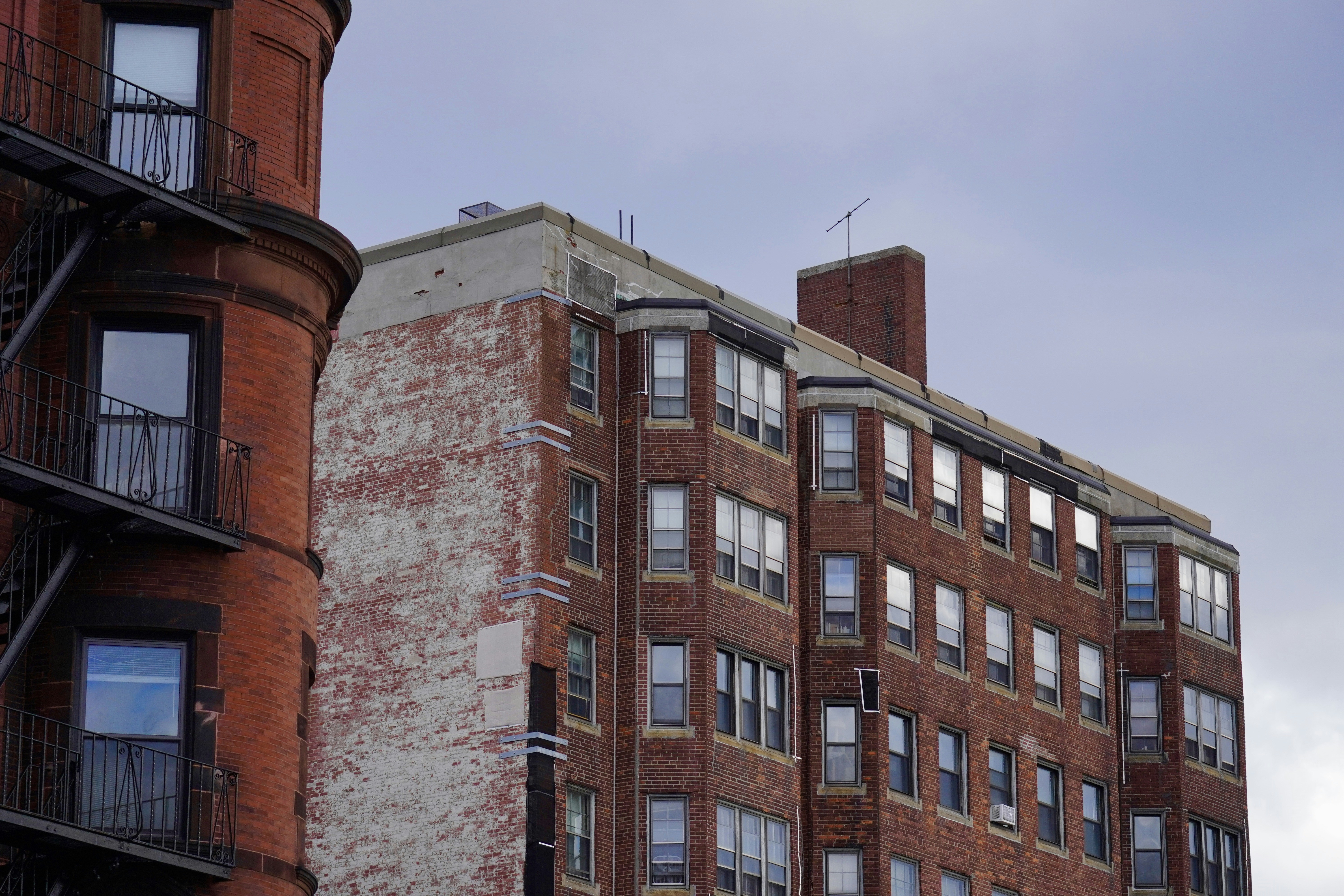 Brick apartment buildings against a cloudy sky