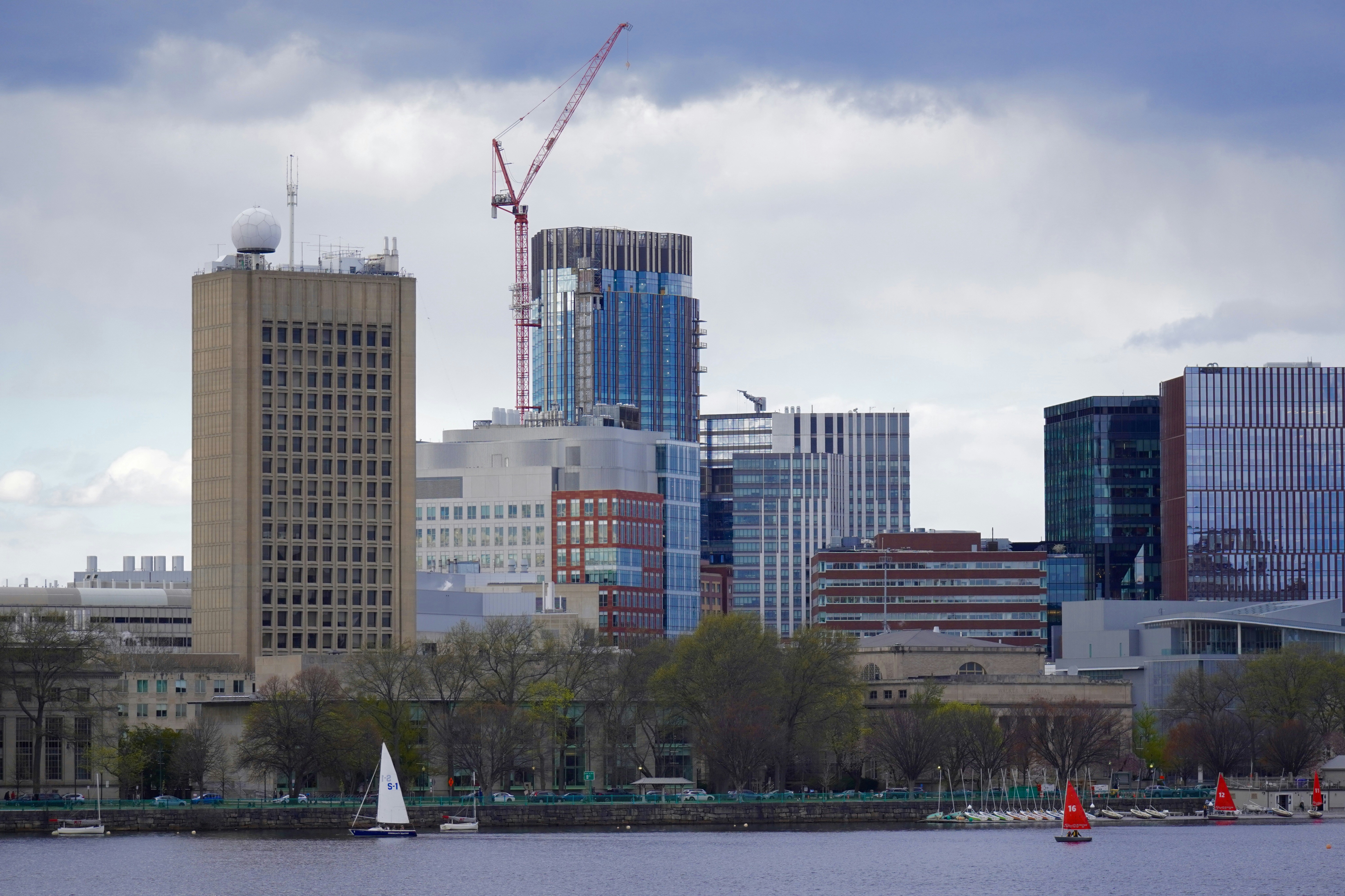 City skyline with modern buildings and sailboats on water