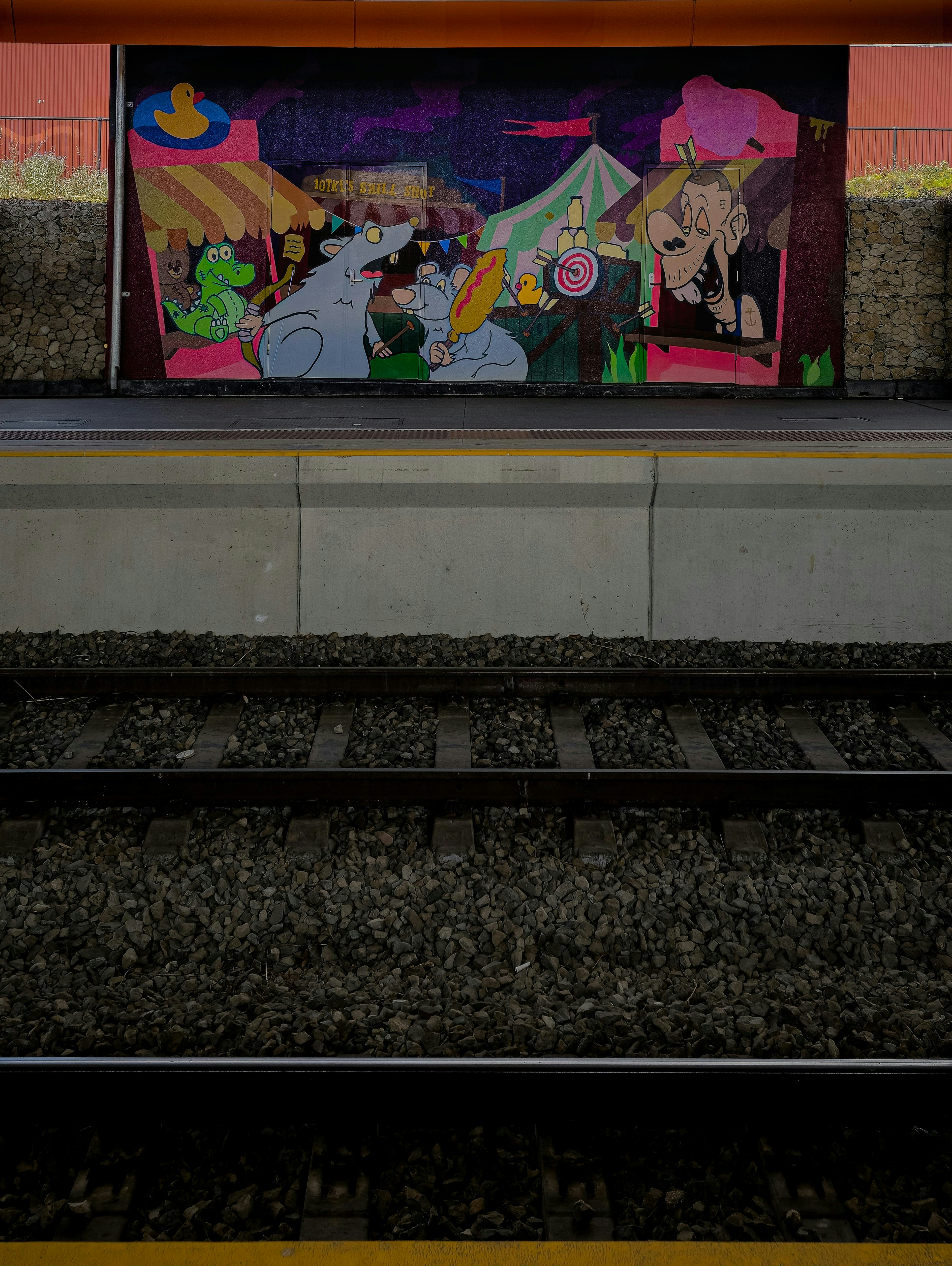 Colorful mural of a carnival scene with cartoon characters.