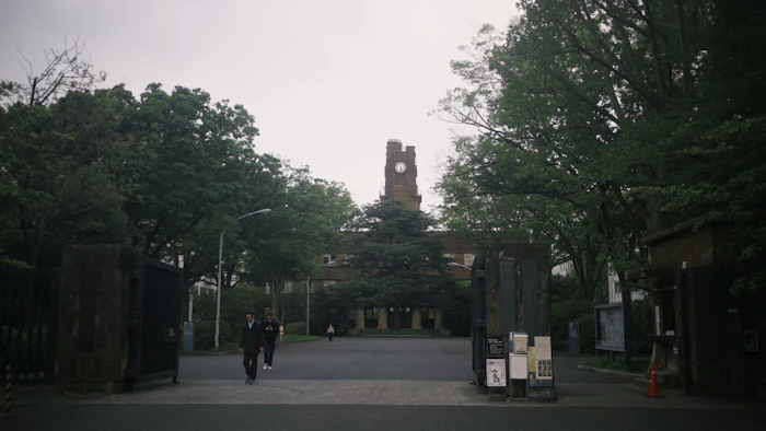 University entrance with clock tower and trees, Kyoto