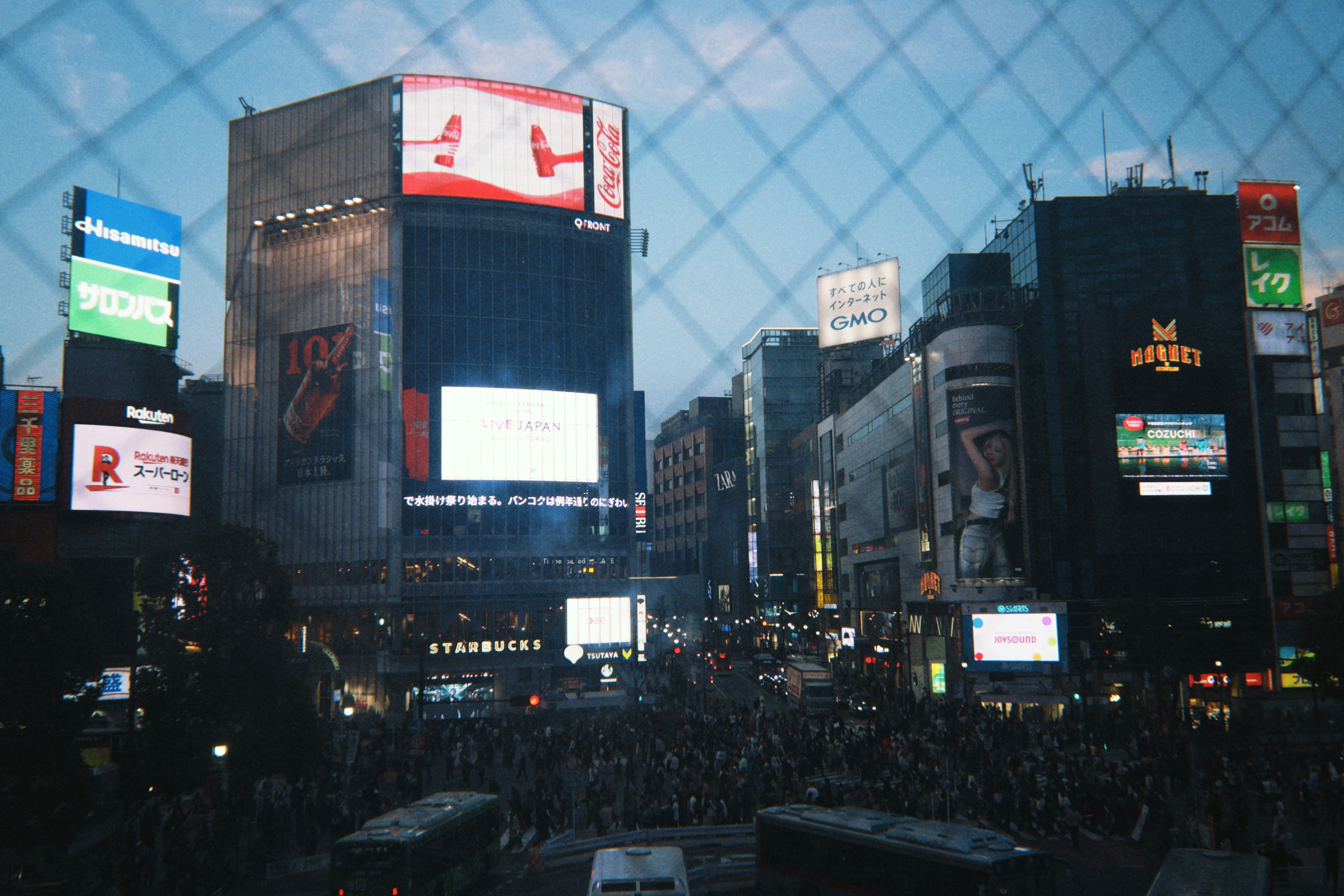 Crowded city street with illuminated billboards at night
