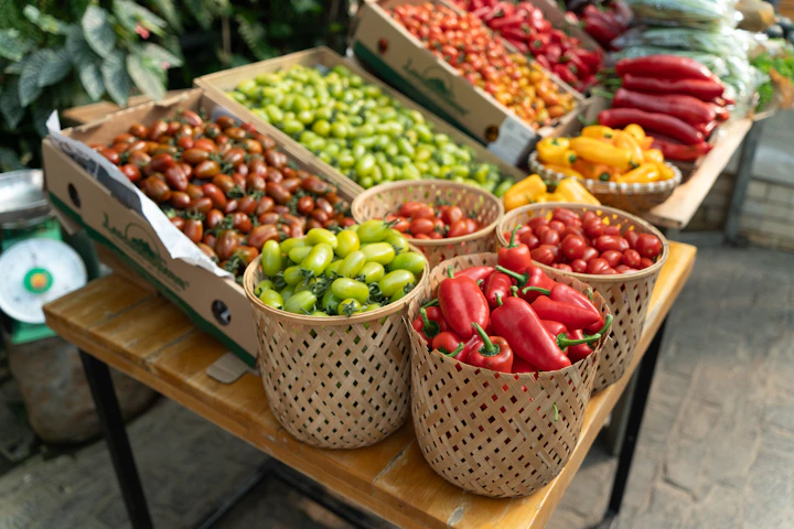 Fresh produce including tomatoes and peppers at a market