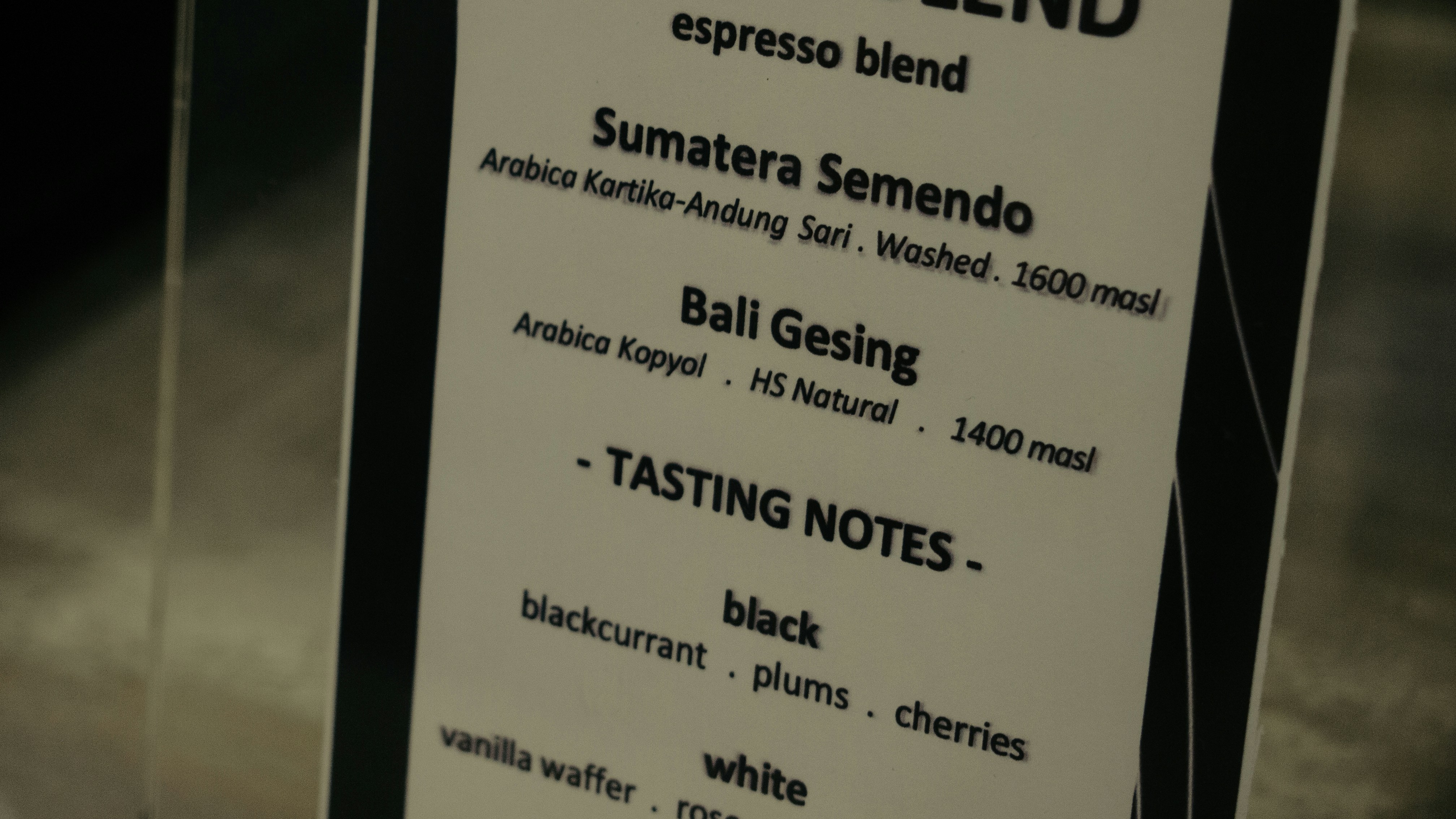 Coffee tasting notes and origin information on a menu.