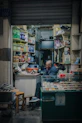Elderly man smoking inside a small convenience store