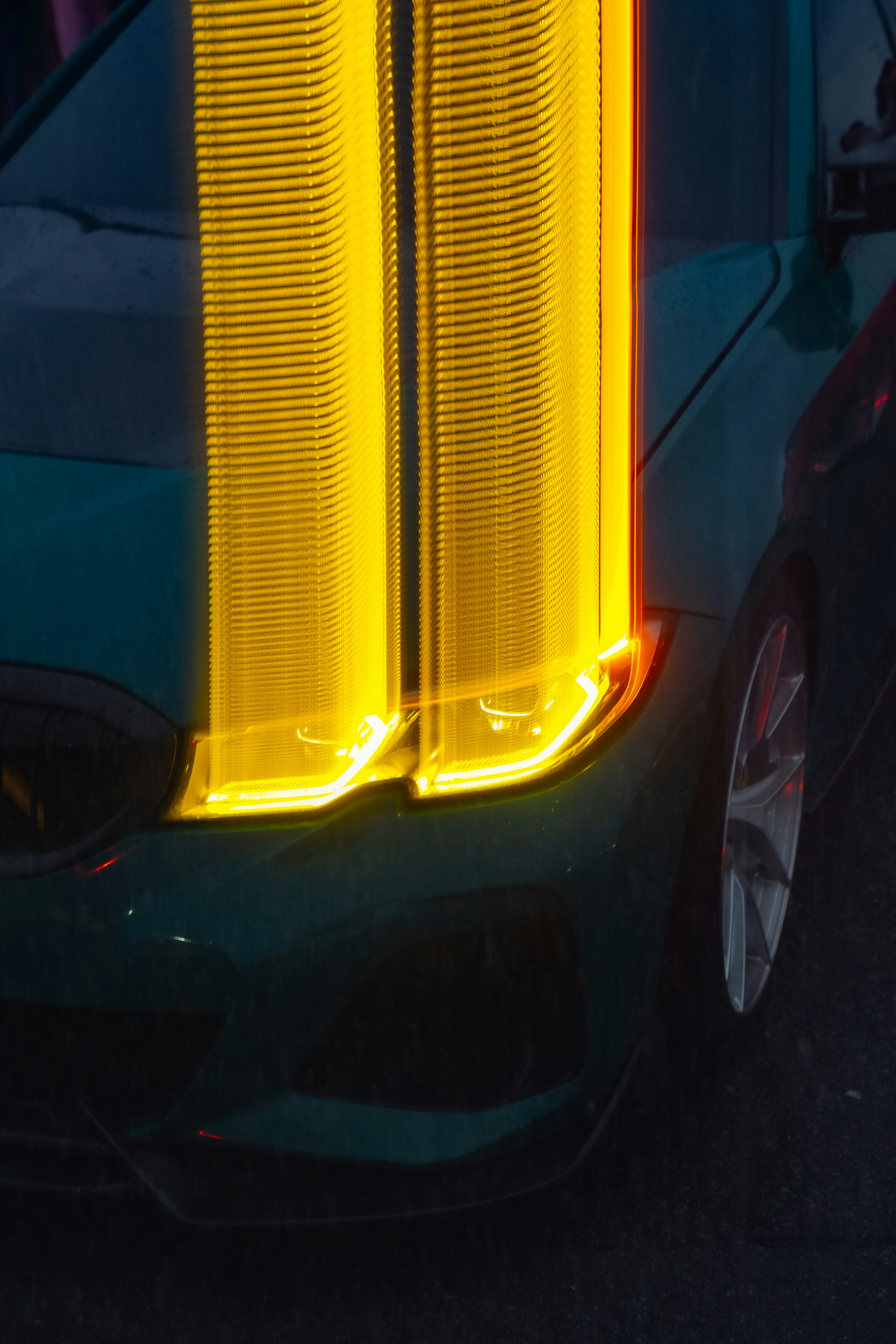 Green car with bright yellow light streaks
