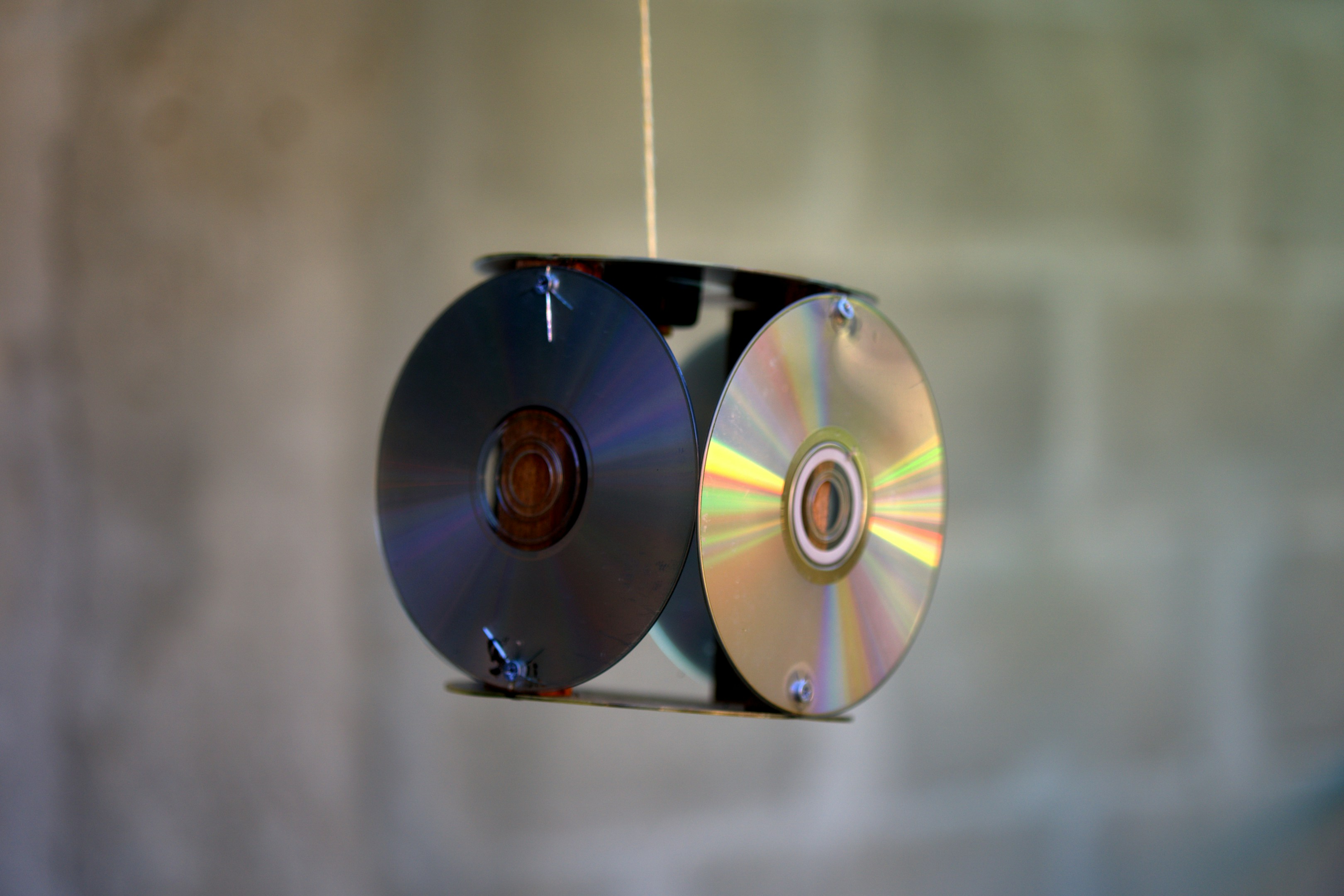 Cds strung together hanging indoors